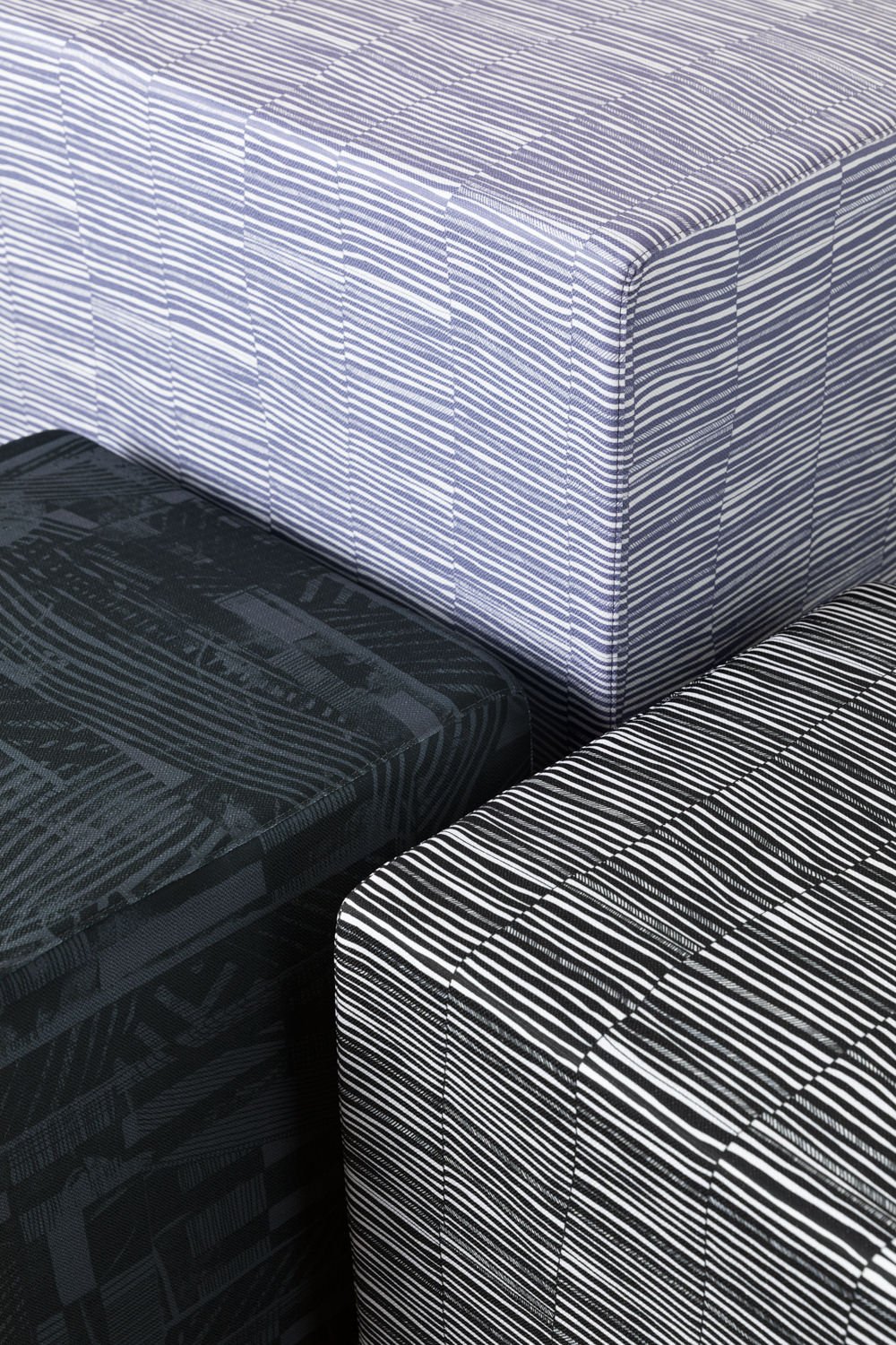 Ottomans upholstered in Willie Weston designs including Oneness 'Oyster', a sophisticated, layered contemporary Aboriginal artwork by First Nations artist Lisa Waup from Naarm (Melbourne).
