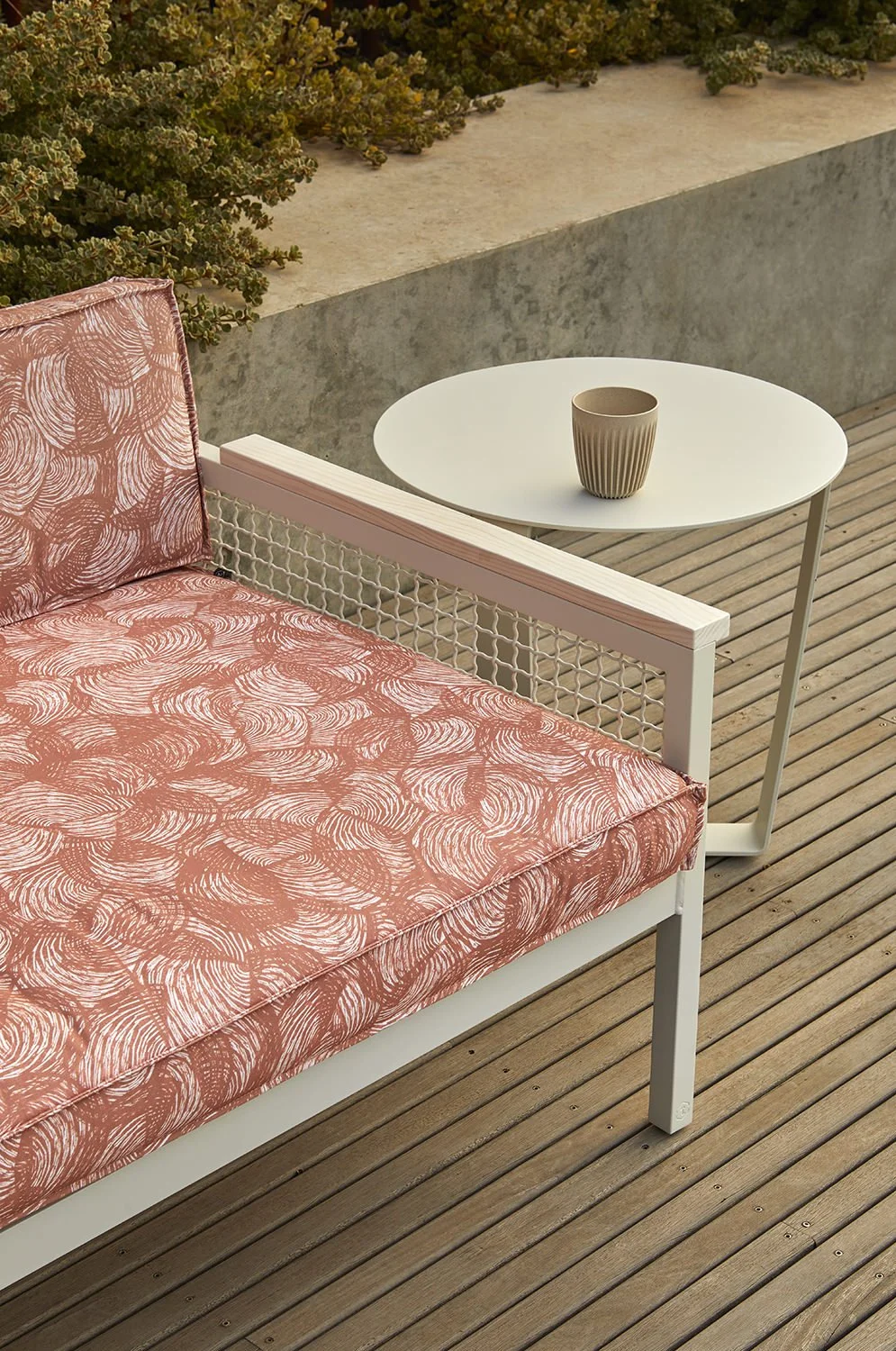 Outdoor sofa upholstered in Willie Weston Rainbows 'Pindan', a delicately patterned contemporary Aboriginal artwork by First Nations artist April Jones from the Kimberley, WA.