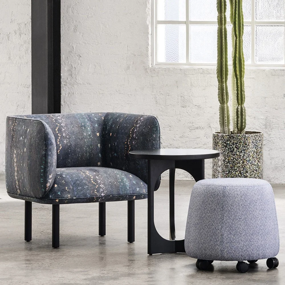 Armchair upholstered in Willie Weston Singing Bush Medicine ‘Night Sky' design, a contemporary floral artwork by First Nations artist Colleen Ngwarraye Morton from Ampilatwatja, NT.