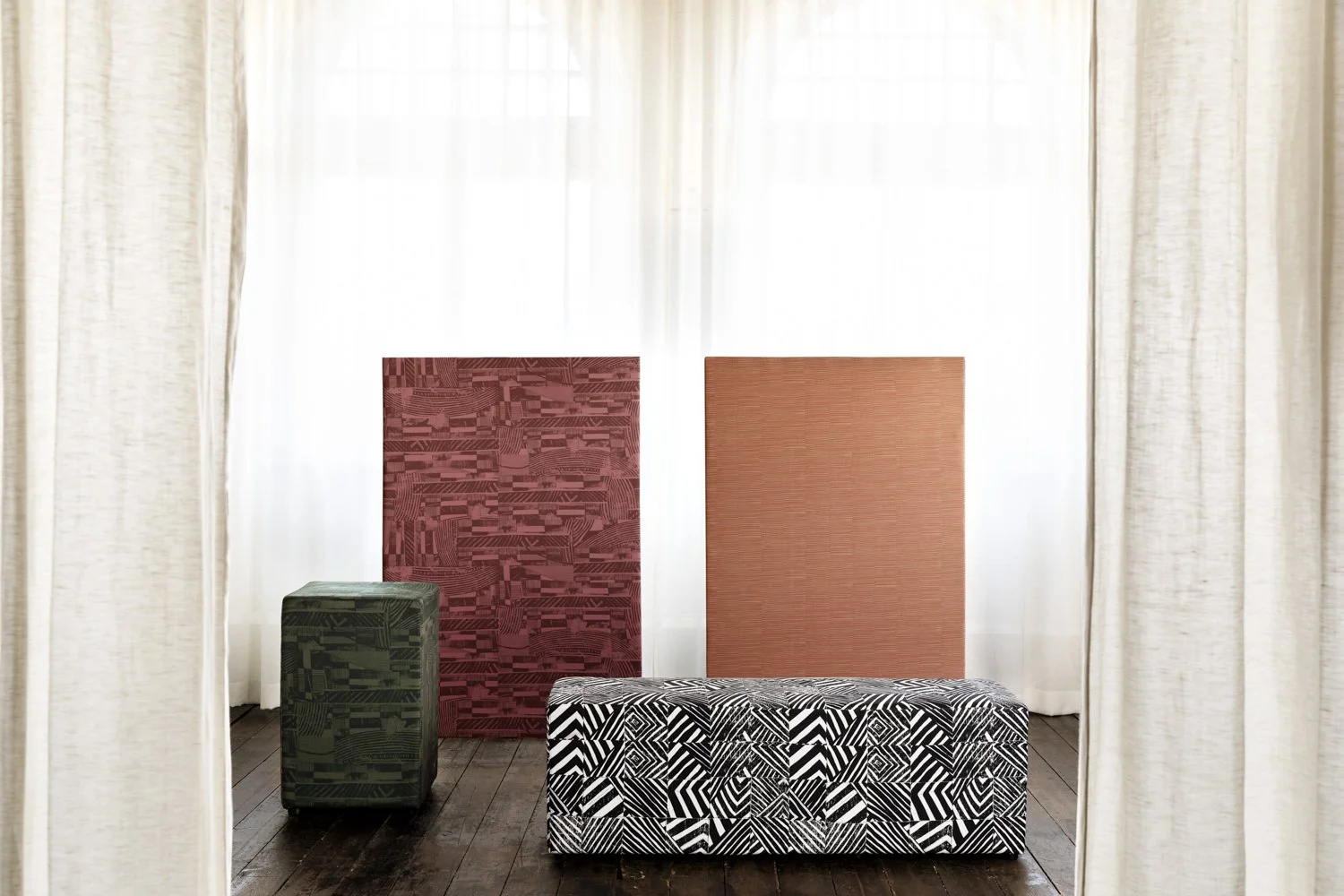 Ottomans upholstered in various Willie Weston designs, including Defragmentation ‘Onyx', a bold geometric artwork by First Nations artist Lisa Waup from Naarm (Melbourne).