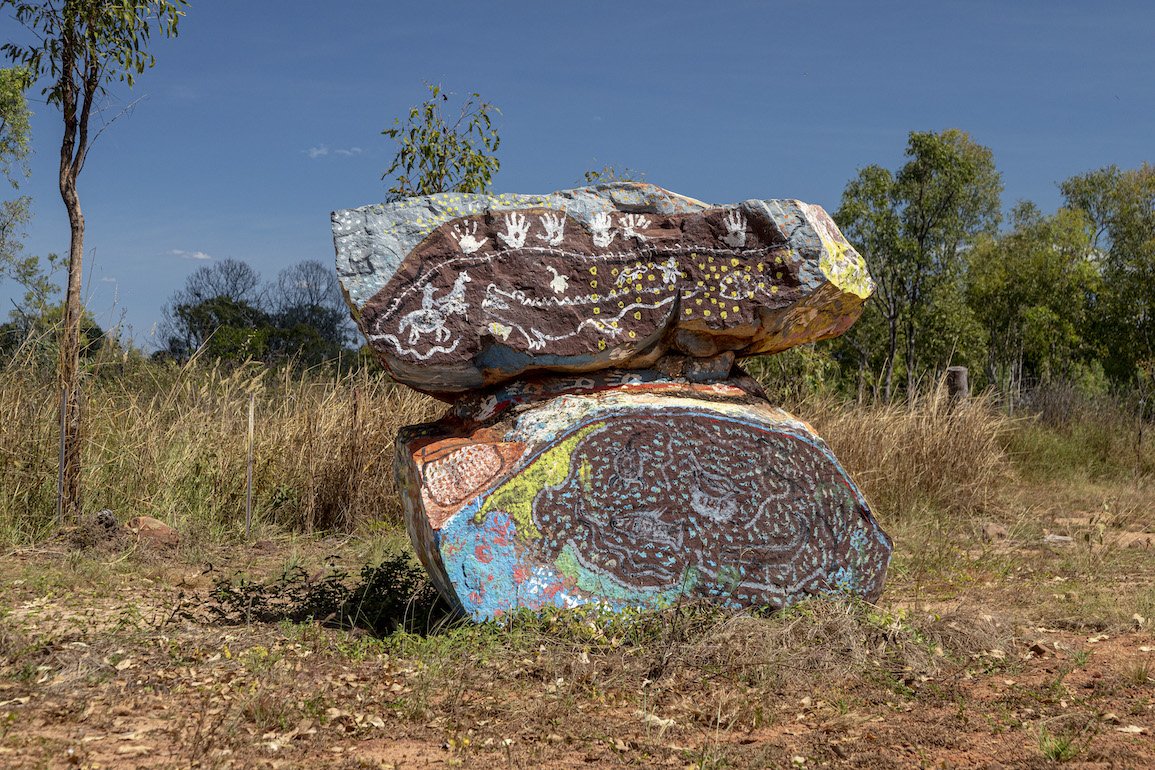 Two large rocks colourfully painted on Country at Peppimenarti, which lies south-west of Darwin.
