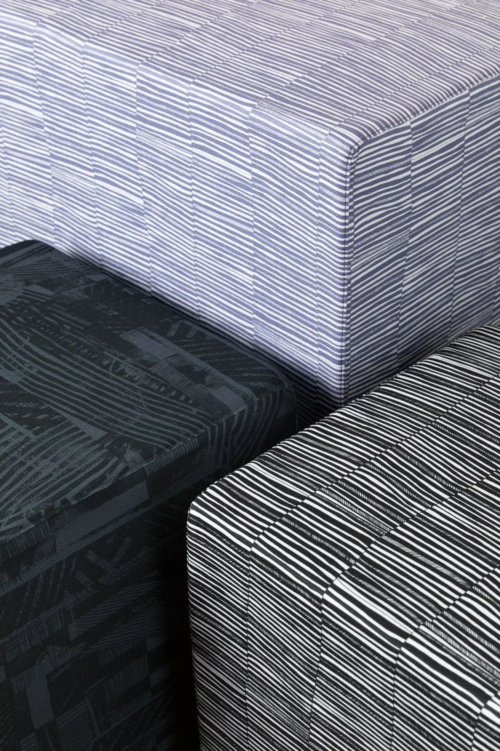 Ottomans upholstered in Willie Weston designs including Renewed 'Mono’, featuring bold, graphic artwork by First Nations artist Lisa Waup from Naarm (Melbourne).