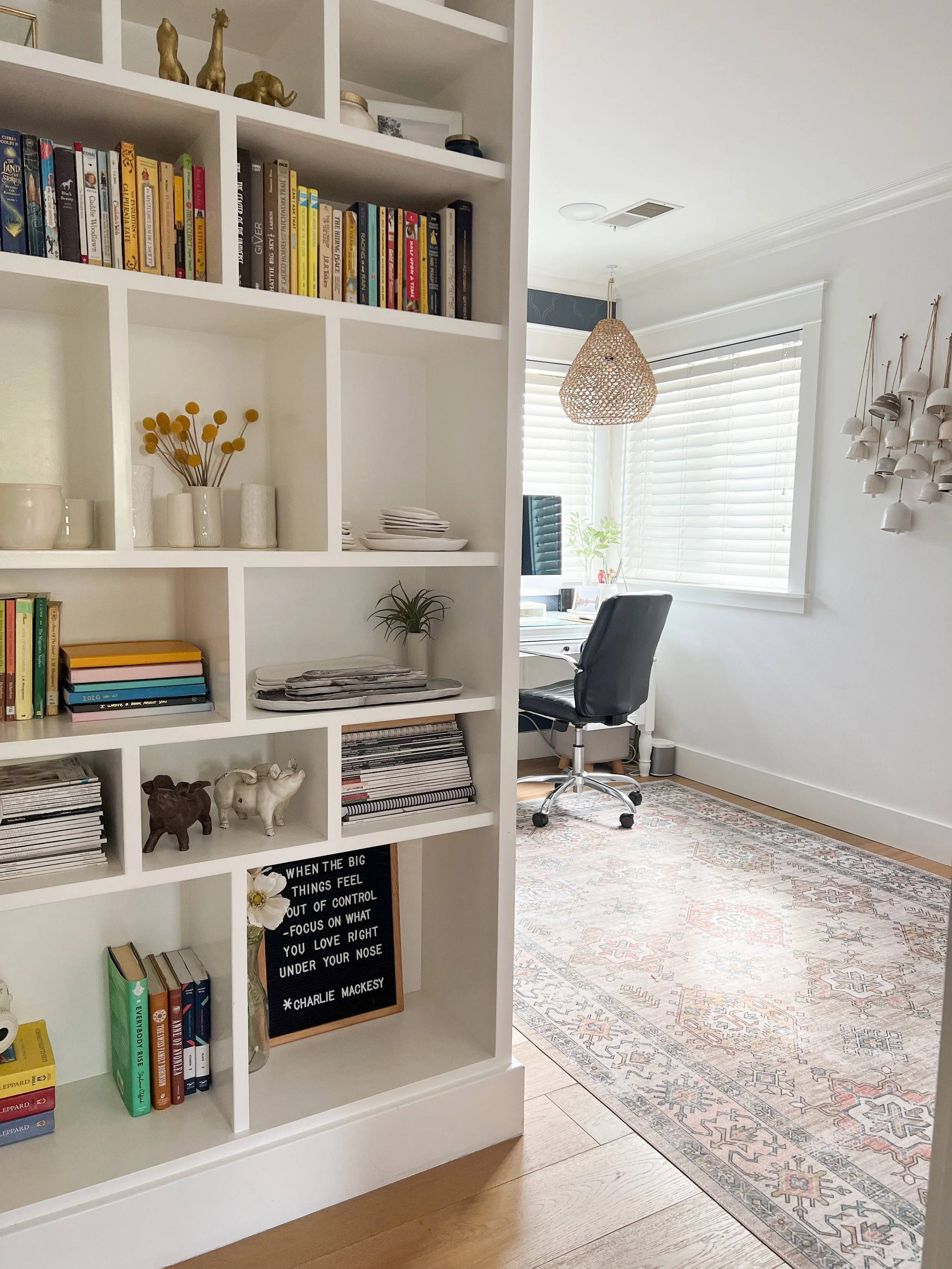 This custom shelving unit was designed to provide an elegant solution for organizing and displaying books, and other treasured items, and fostering visually appealing organization within the space constraints of a smaller bedroom shared by two.