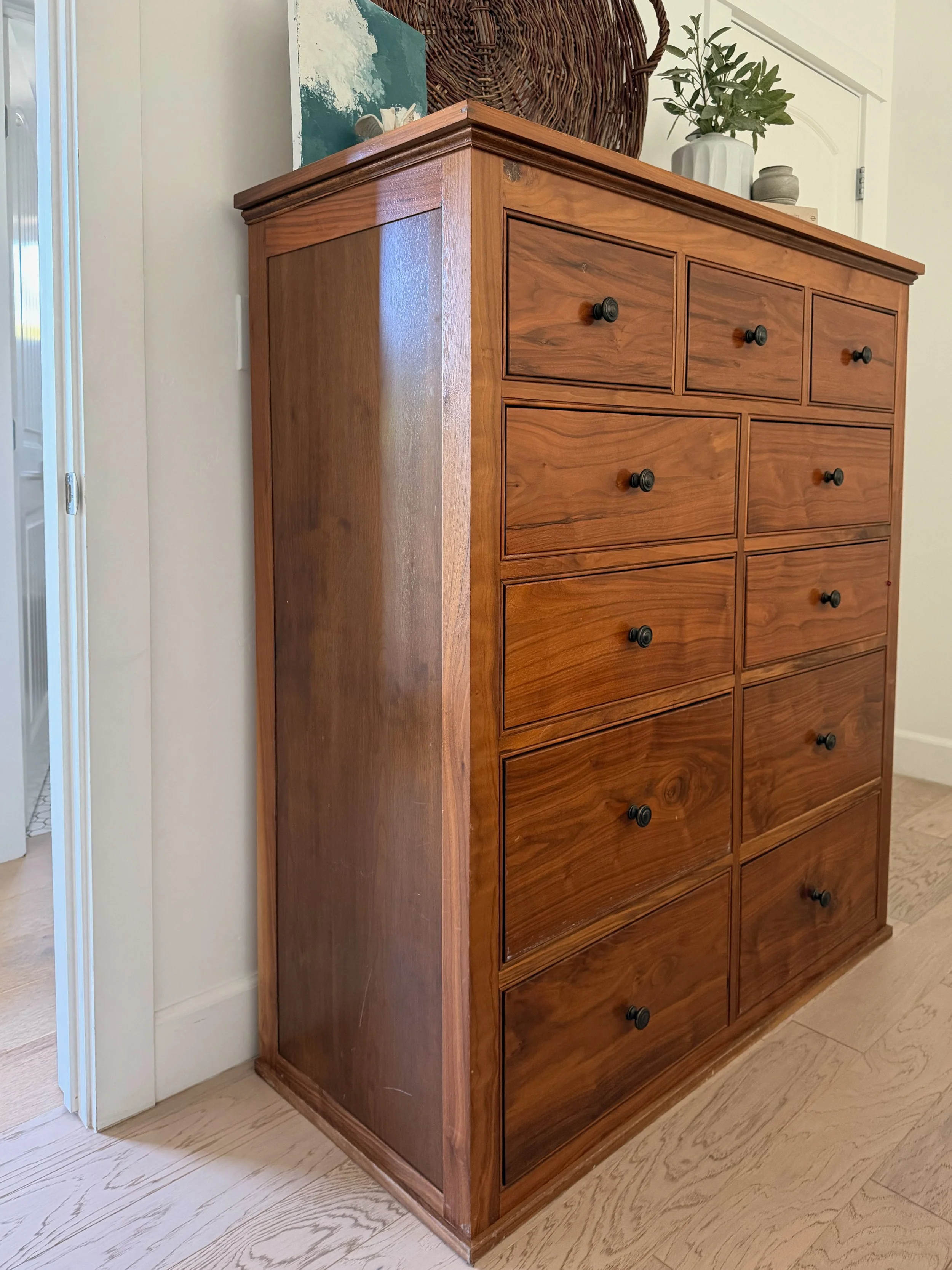 This walnut dresser was specifically designed with storage for two, materials used, and a pleasing aesthetic in mind.  Its transitional style included refined details in the molding, bead detail and size.