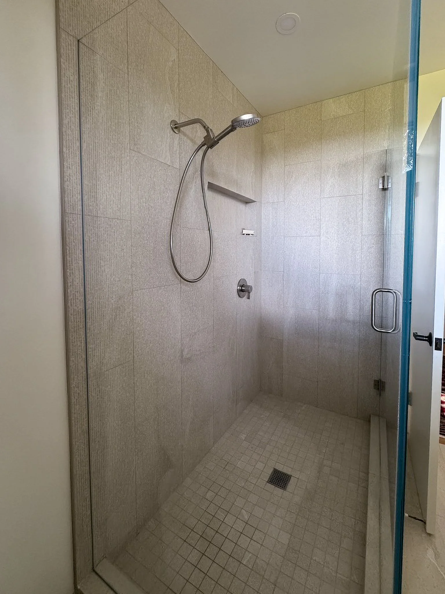 Clean lines and diverse use of the same hue of tile create interest while bringing a cohesive look to the entire room.