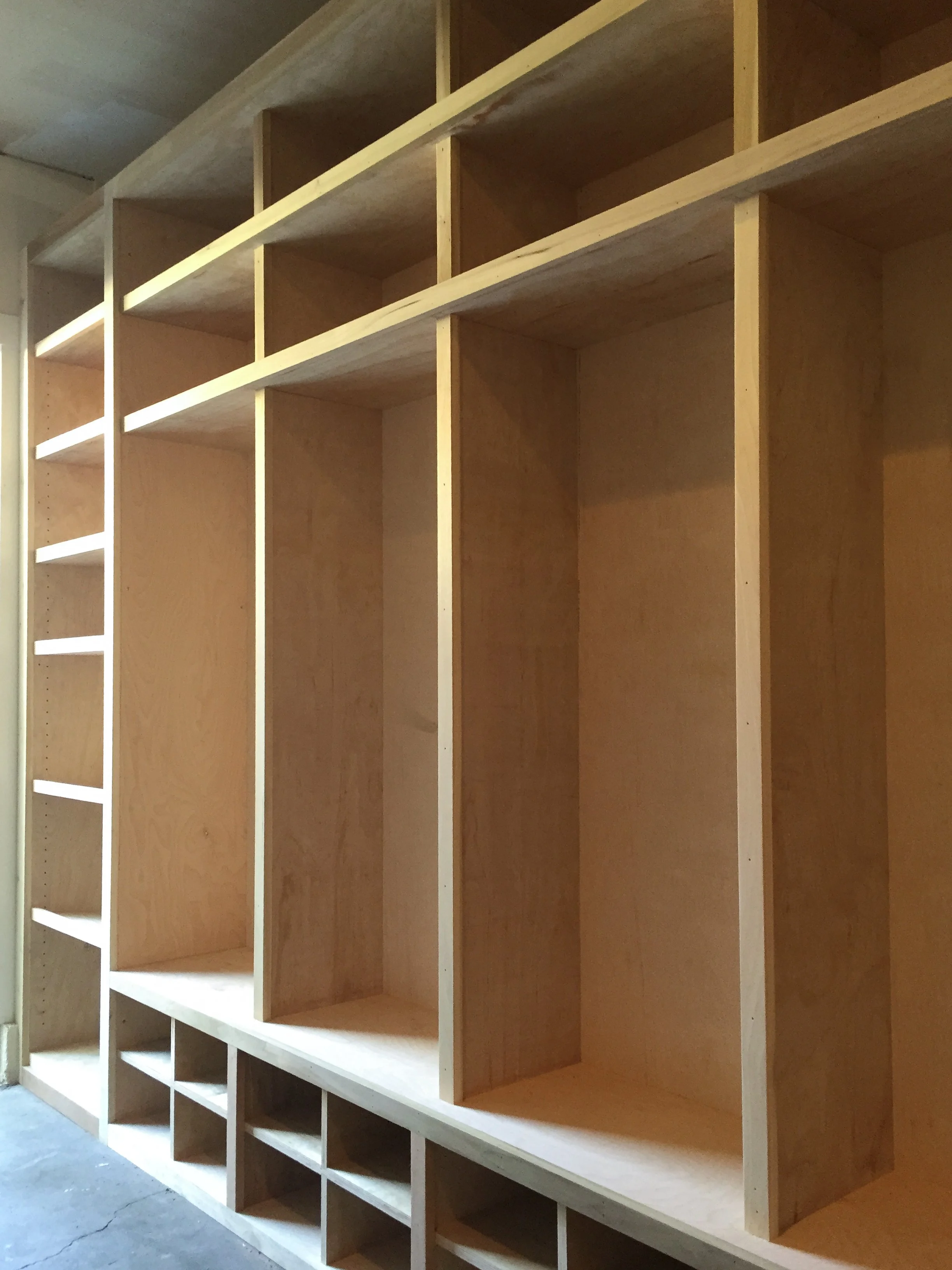 This locker inspired cabinetry was created to provide organization, and a large storage solution in a laundry room.  It gave each person in the family a place to put shoes, sporting equipment, and other items in consolidated, beautiful space.