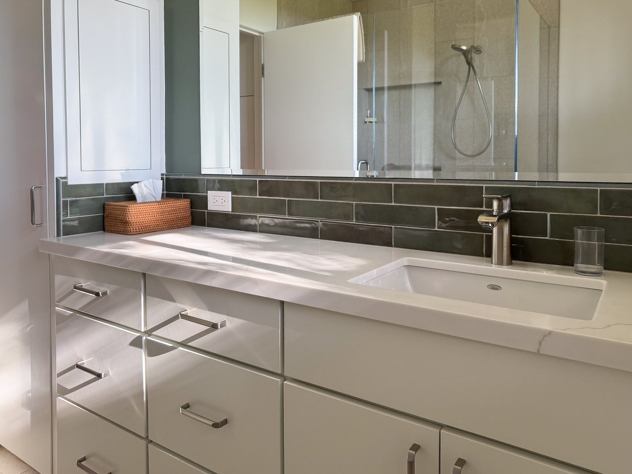 The green tile and paint, give this space a needed splash of refreshing color