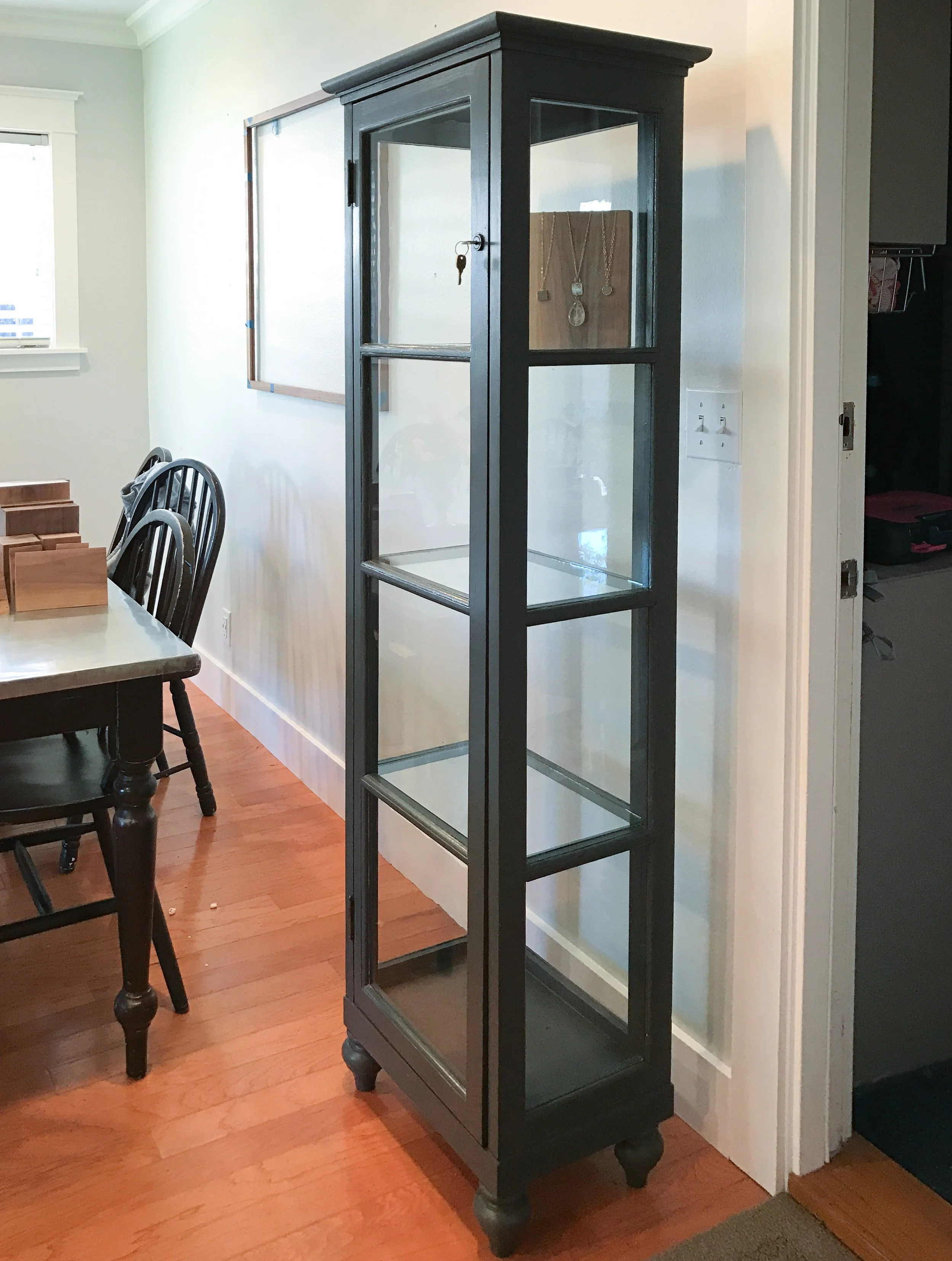 This custom display cabinet was crafted from four vintage windows to display jewelry at a local salon.