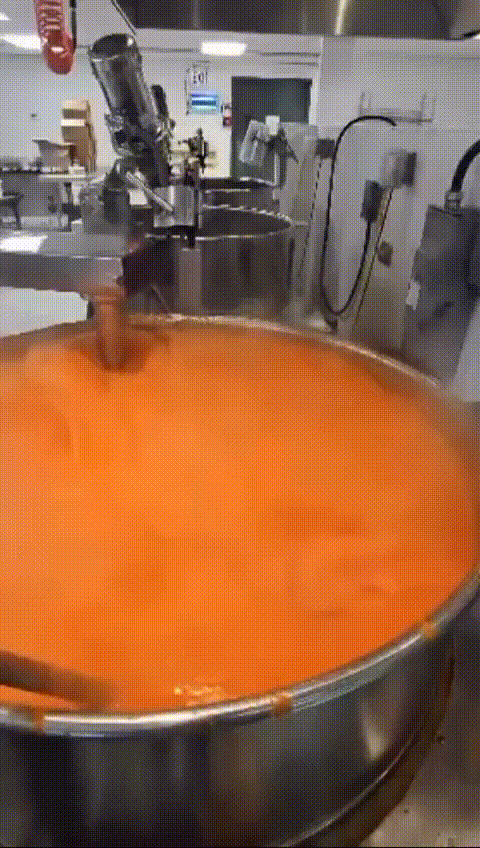 Large batch of authentic Nigerian pepper sauce being cooked and prepared in a commercial kitchen