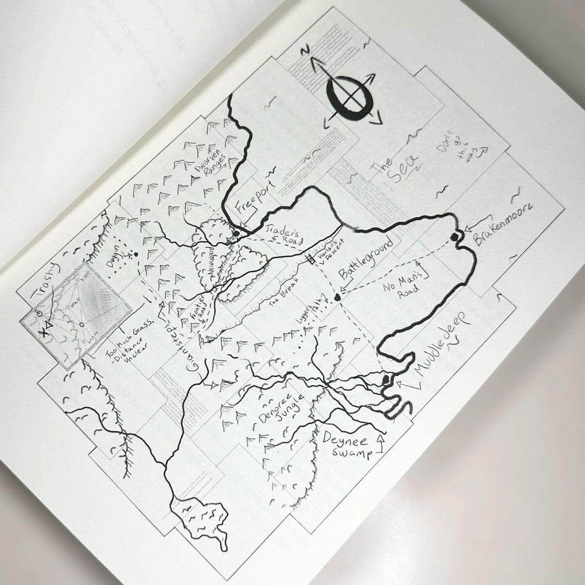 Hand-drawn map of a wilderness area with rivers, mountains, forests, swamp, and various landmarks labeled, including a jeep trail, battleground, and no man's land.