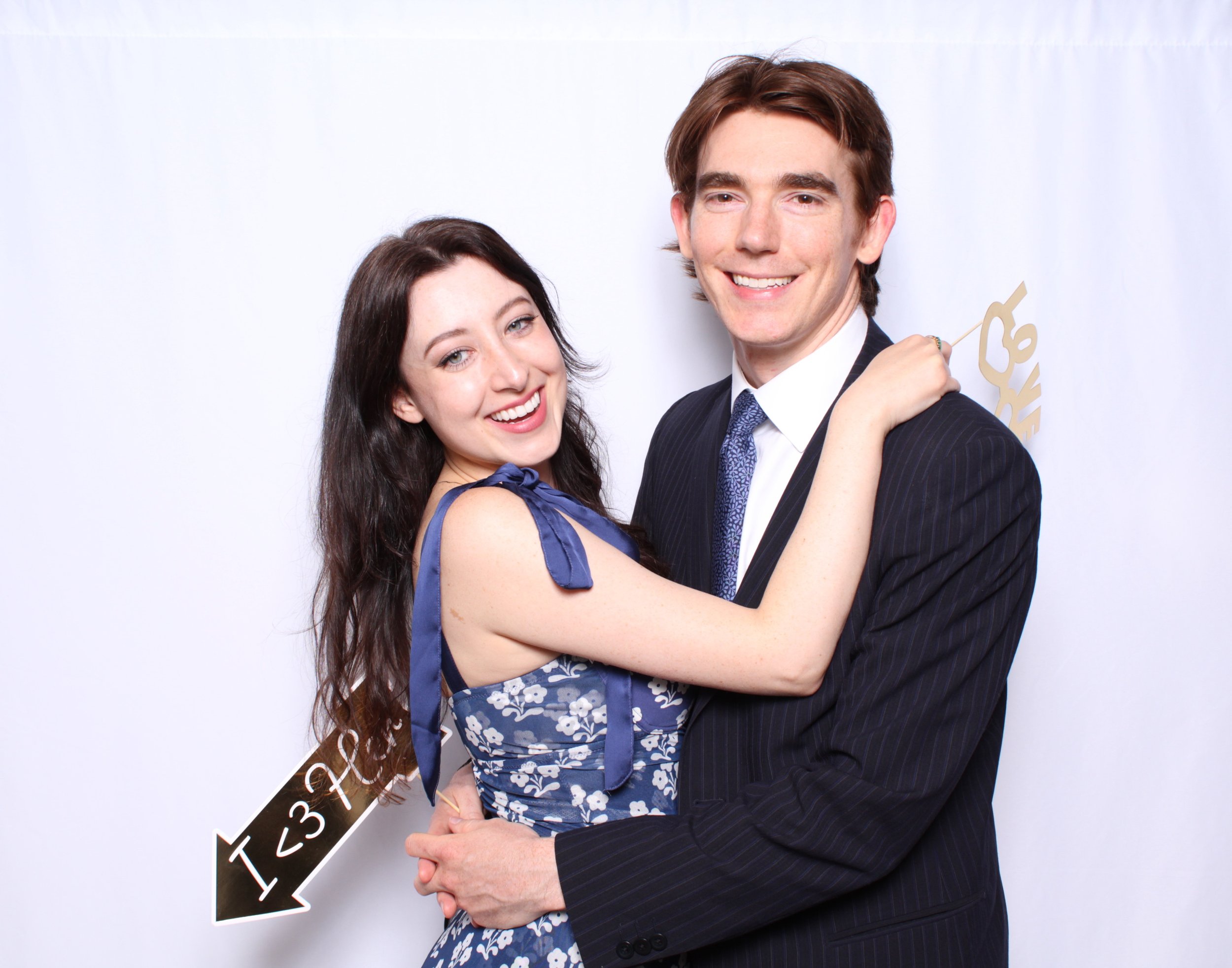 Cute Couple making memories at the photobooth at the wedding they attended in Toronto.