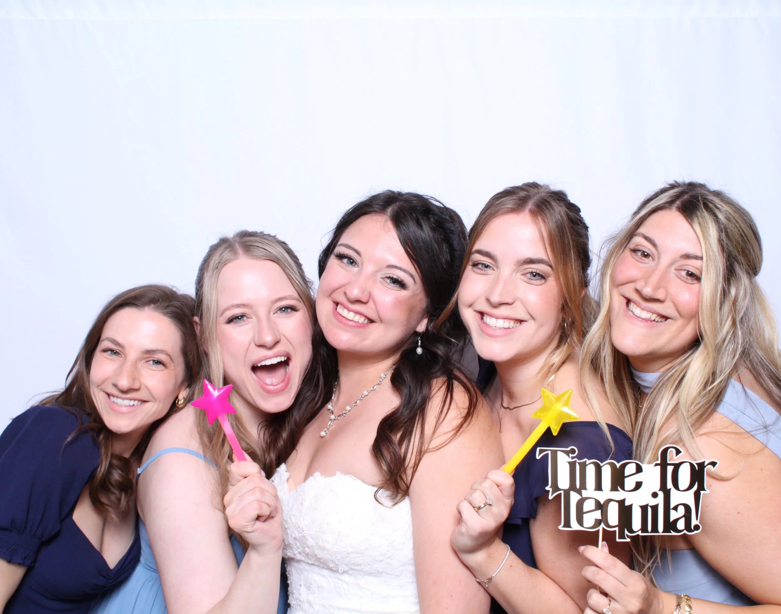 Bride and her brides maids taking enjoying the photobooth experience at their Wedding in Toronto.