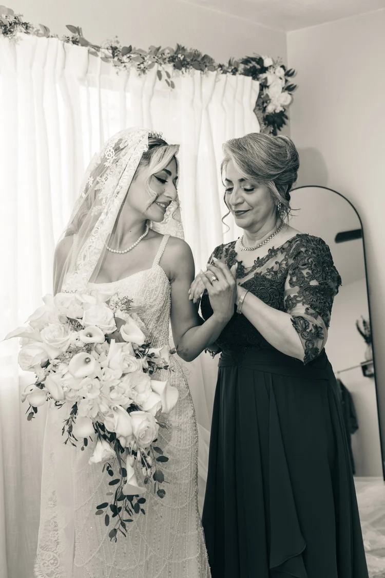 Bride sharing an emotional moment with her mother, black and white