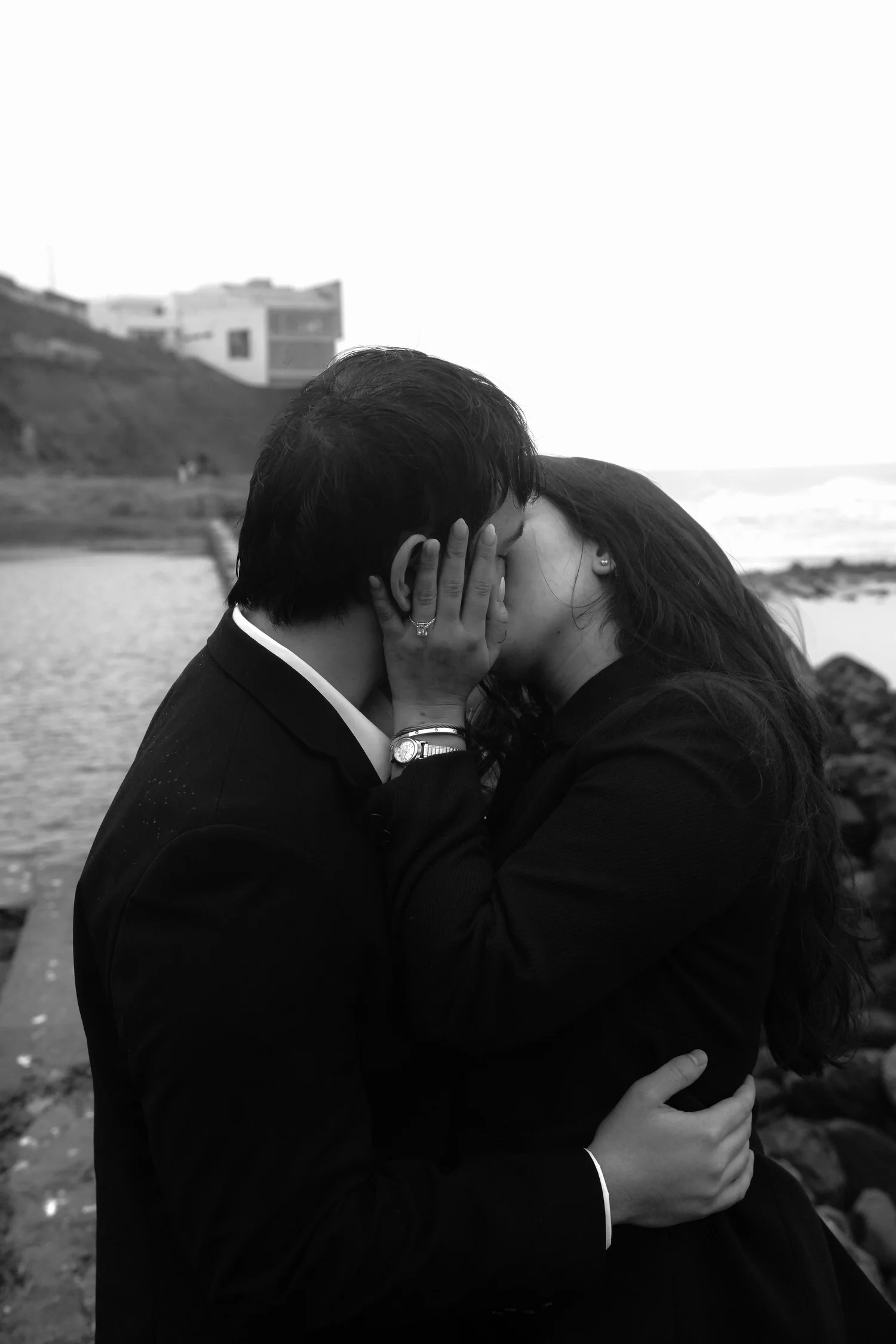 Couple sharing a kiss on the San Francisco coast, black and white