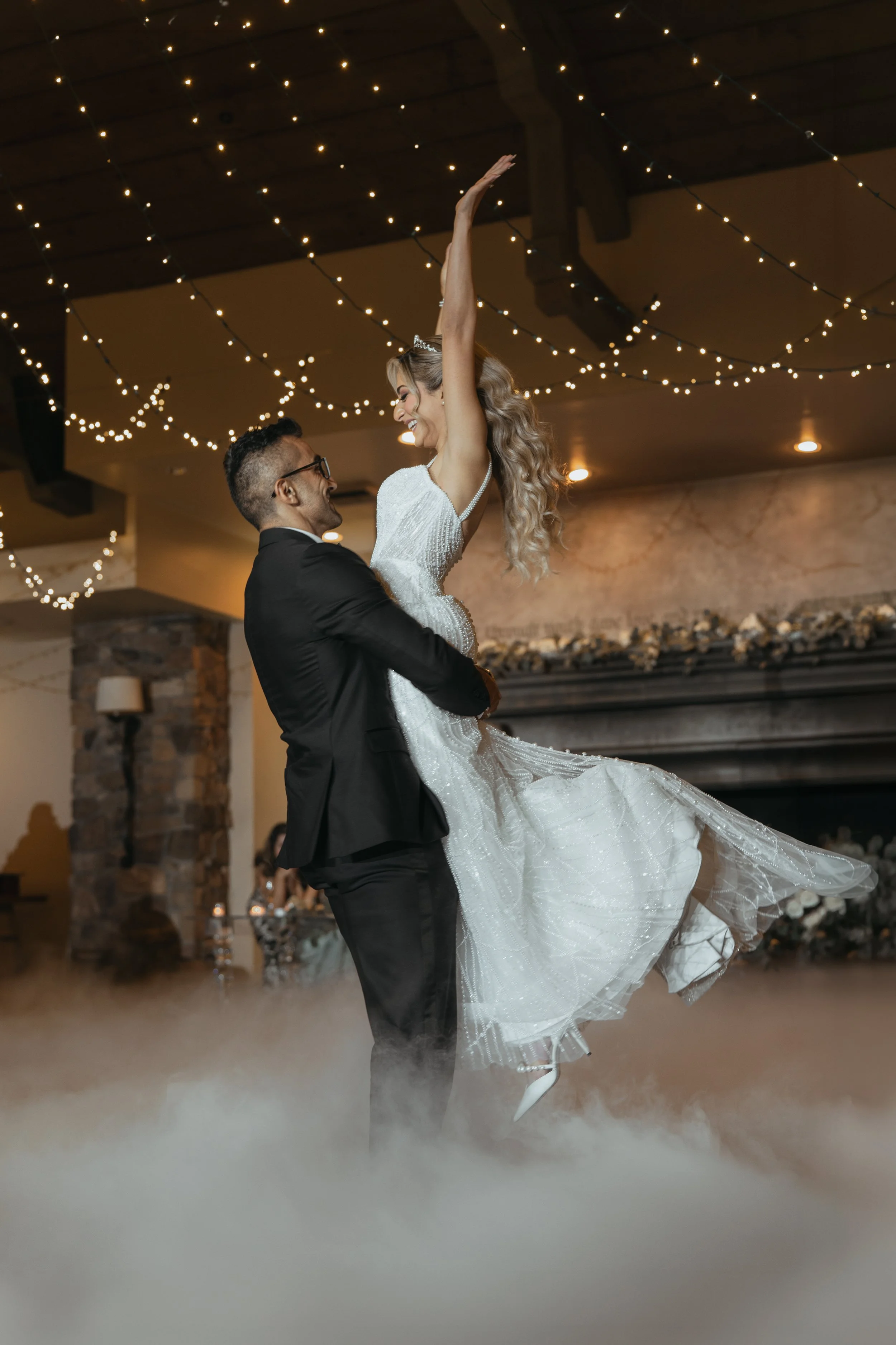 Bride lifted by groom during their first dance at a Bay Area wedding reception, captured in cinematic natural light by Lei Photography Collective.