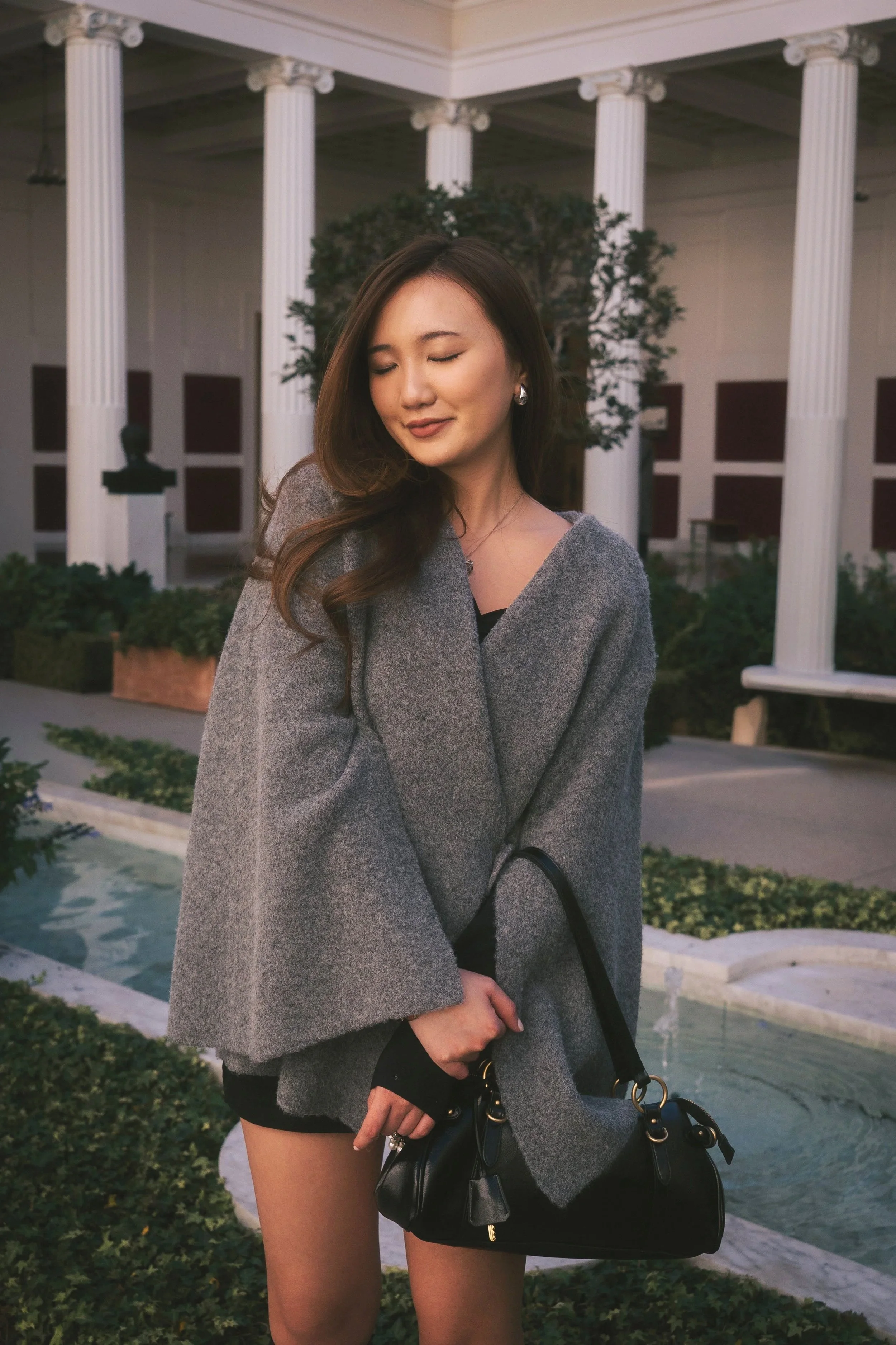 Fashion editorial portrait of a woman posed outdoors in natural light, photographed by Lei Photography Collective.