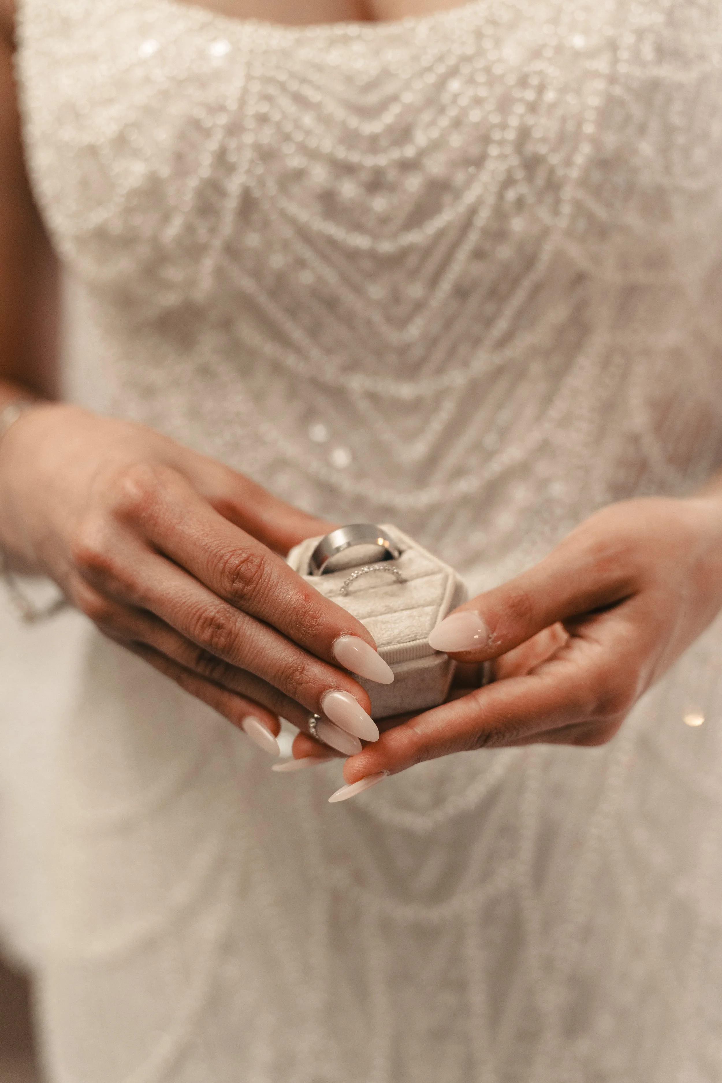 Close-up of wedding rings held in hands during a Bay Area wedding, photographed in natural light by Lei Photography Collective.