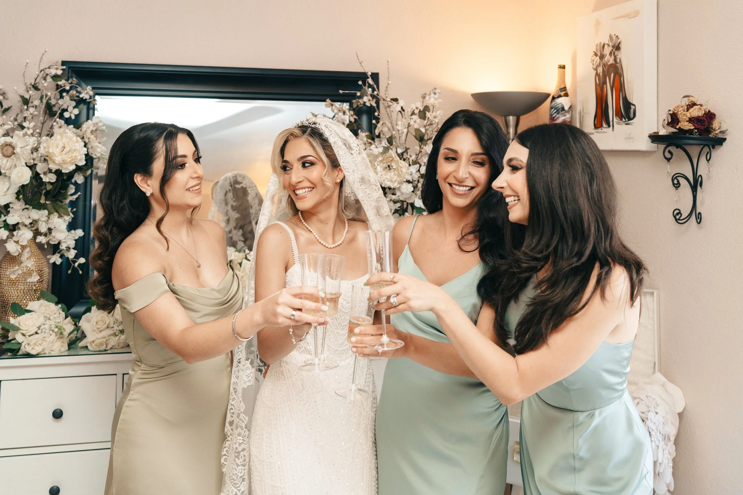 Bride celebrating with bridesmaids during wedding preparations in natural light at a Bay Area wedding, photographed by Lei Photography Collective.