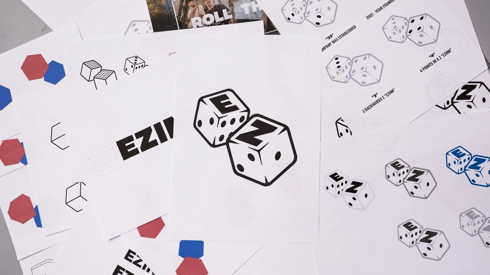 Several sheets of paper with illustrations and instructions for a game called EZINK, featuring dice and color hexagons.