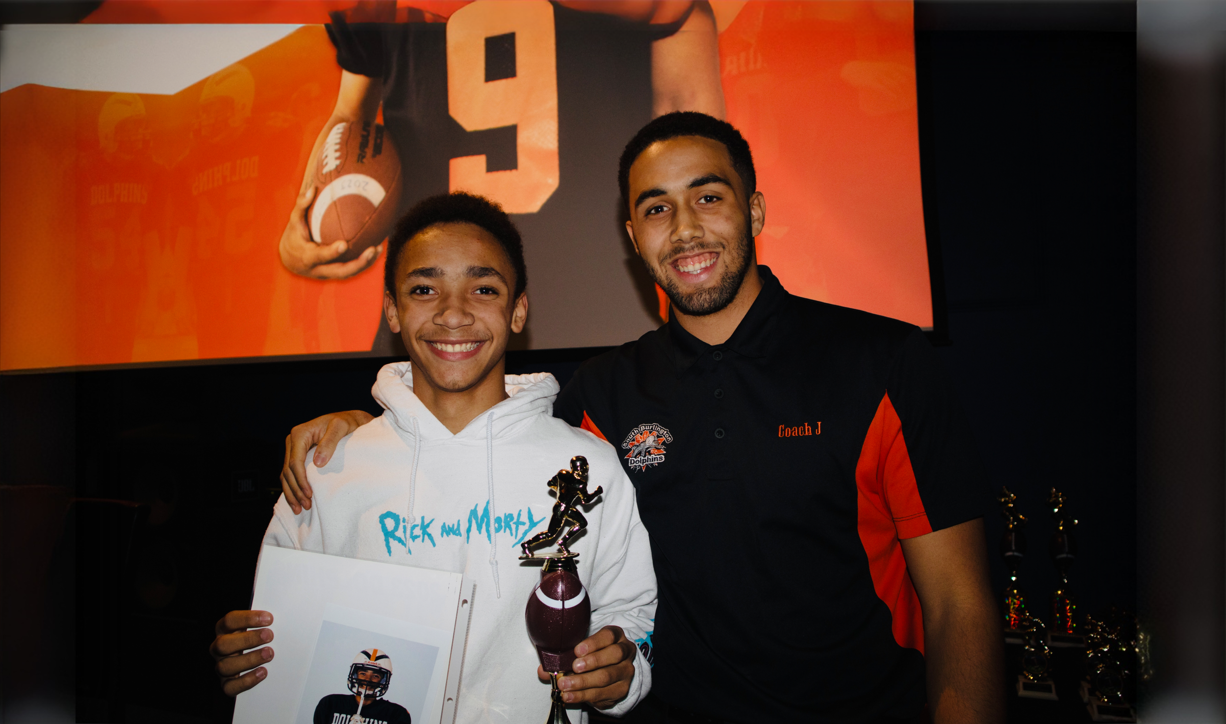 Javen Sears alongside Jaymin Lyman-Cobbs at the 2023 South Burlington Dolphins Award Show, presenting trophies to the players