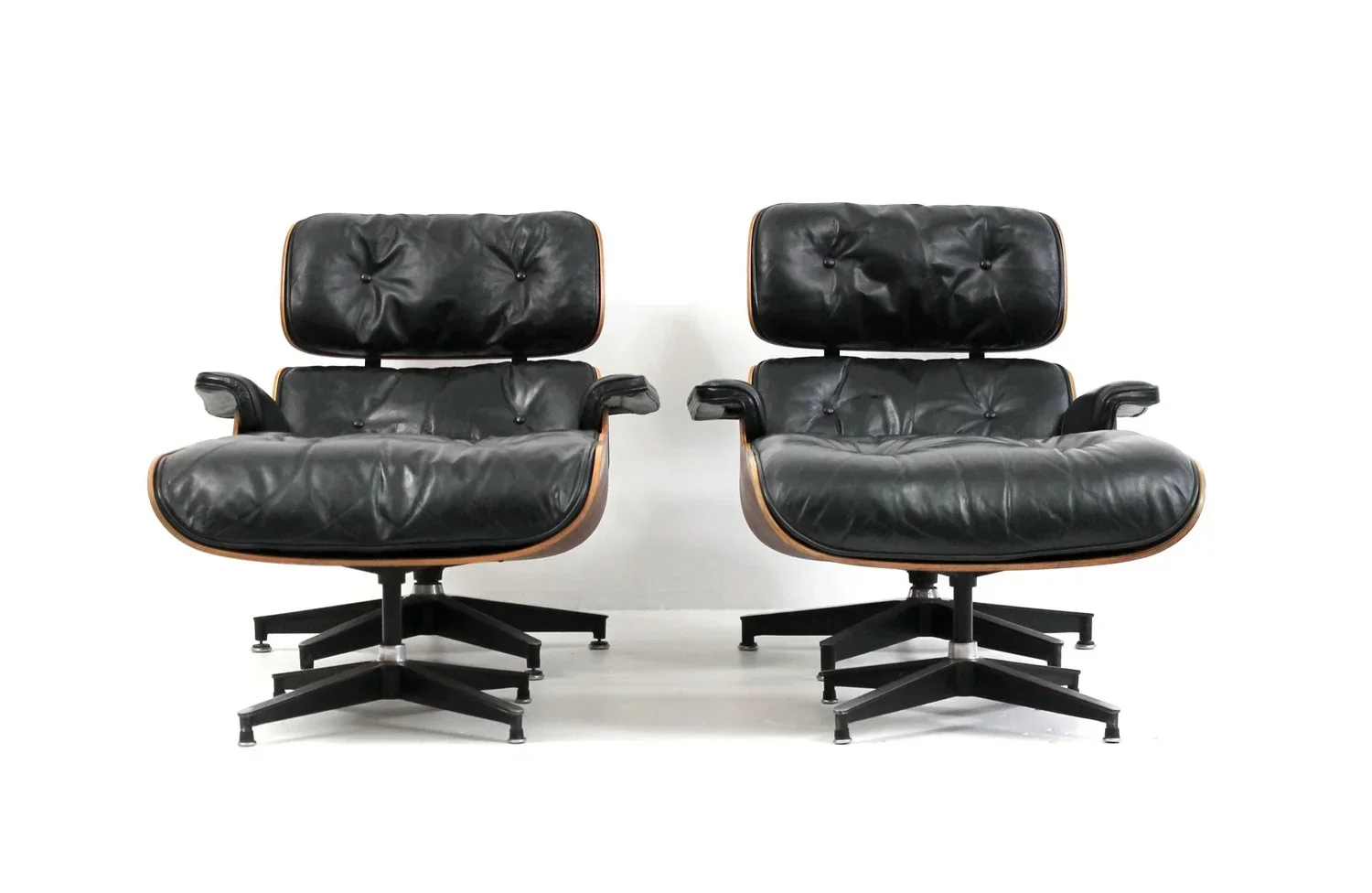 2 black restored Eames lounge chairs