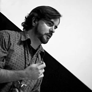 Black and white photo of filmmaker Jerry Rapp teaching a screenplay writing class