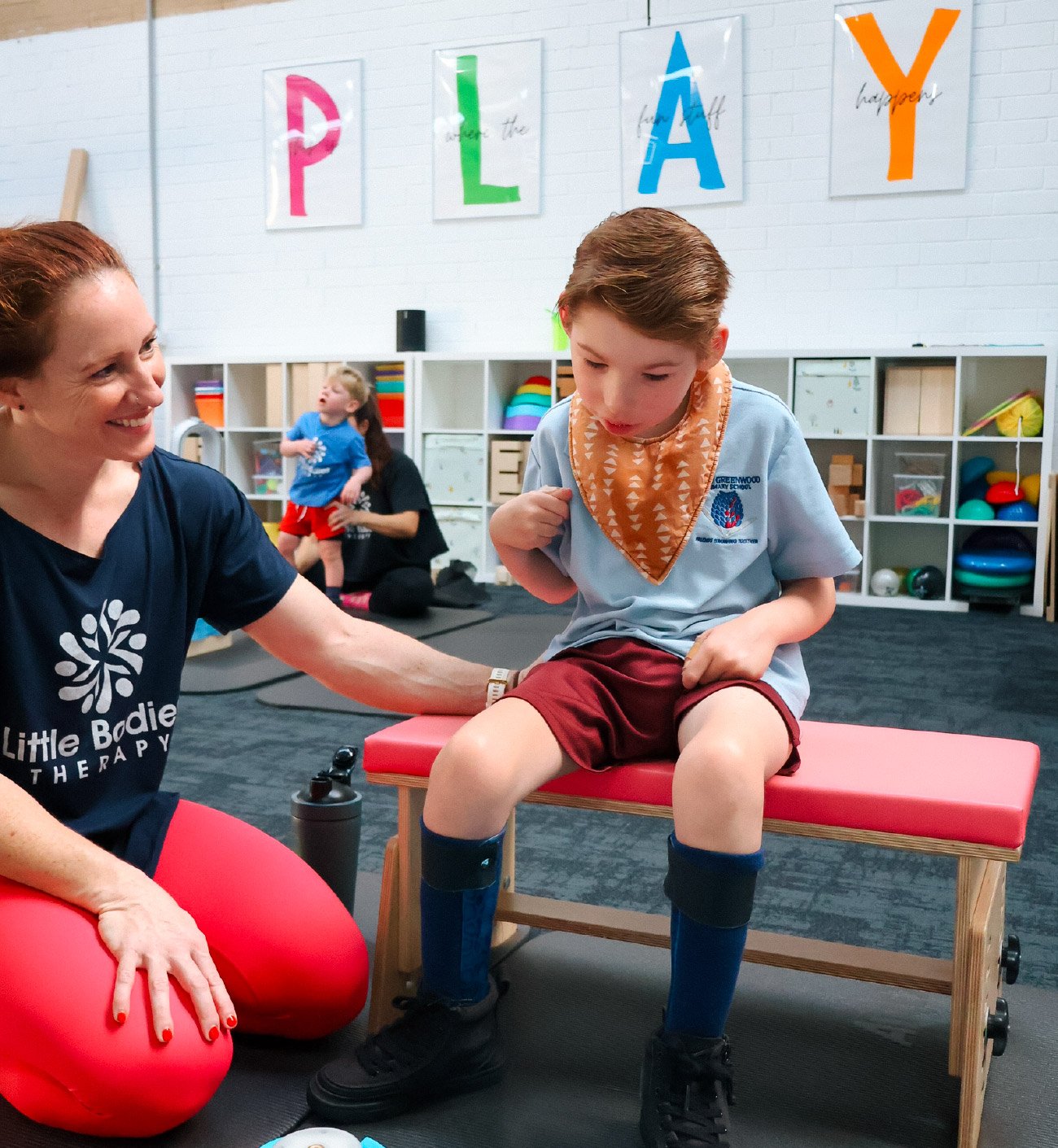 Child engaging in early intervention play-based therapy with a clinician to support foundational movement and learning skills
