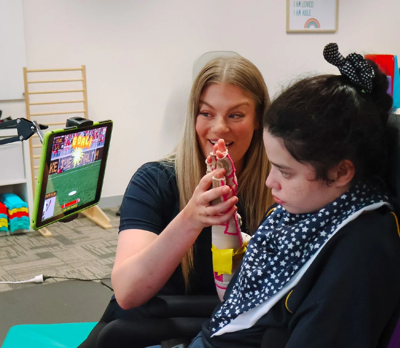 Child practicing hand-eye coordination and fine motor skills with occupational therapy assistive technology