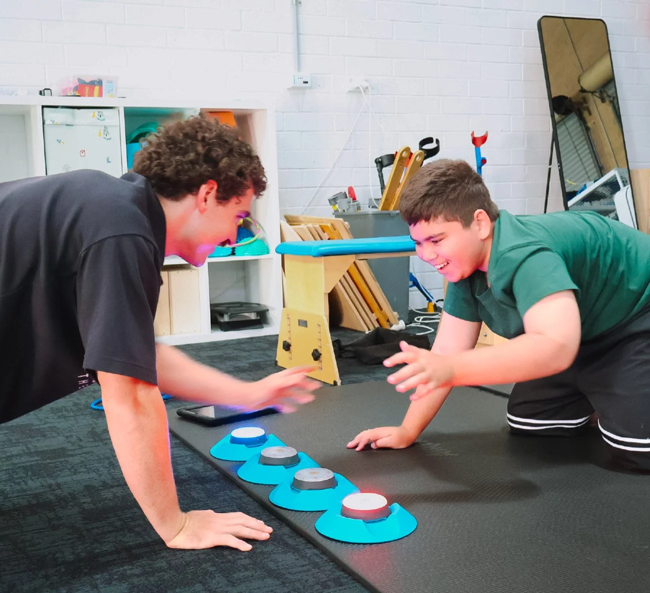 Child engaging in playful gross motor activities to support movement coordination and fitness during an exercise physiology session