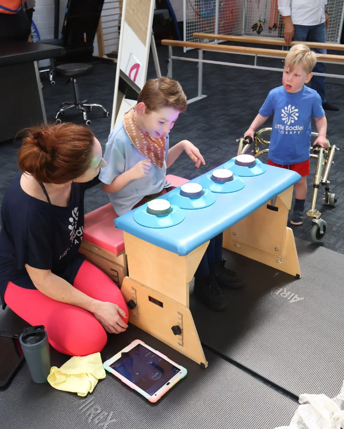 Therapist supporting a child during a playful therapy activity in the clinic
