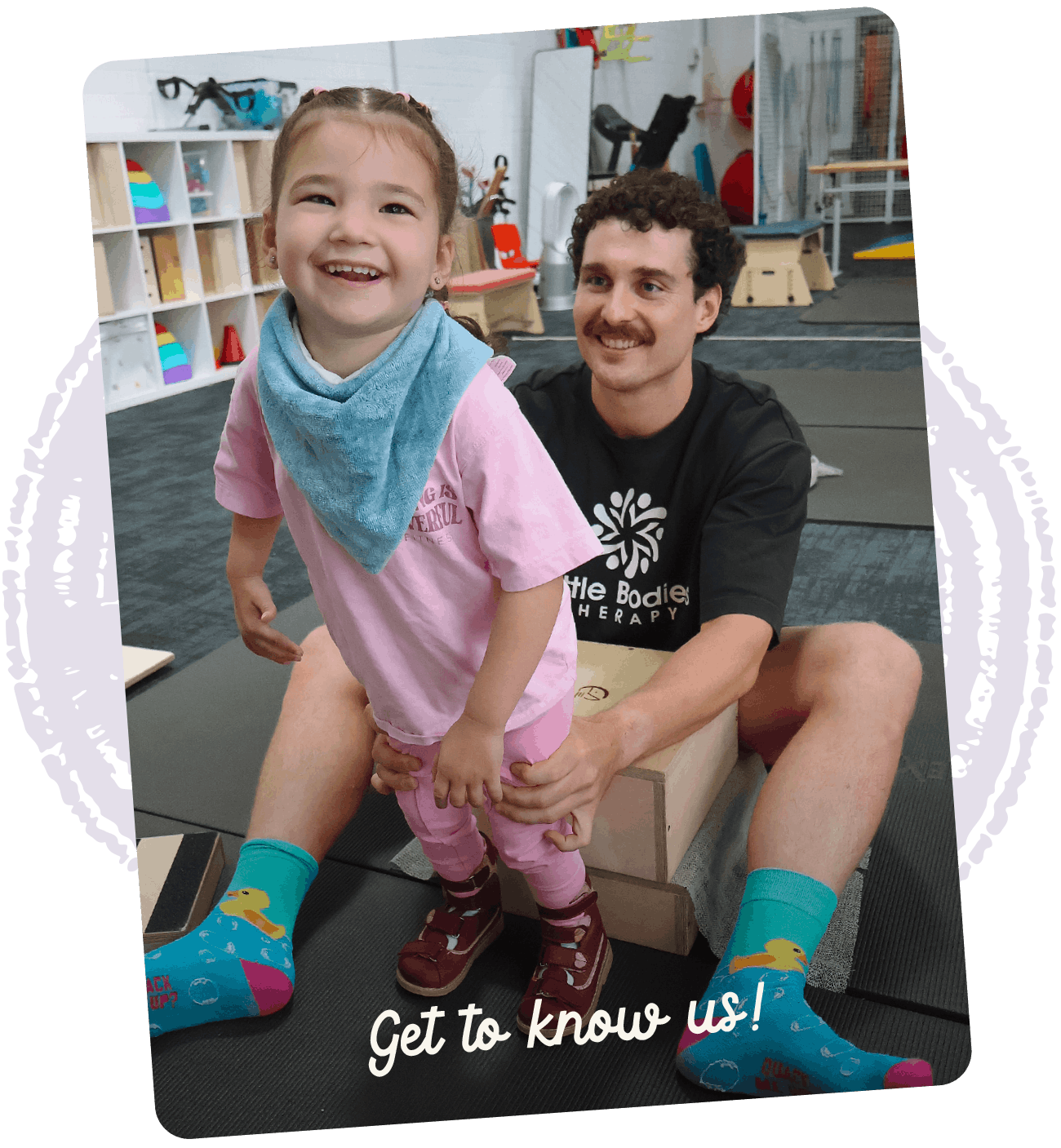 Paediatric therapist smiling with a child during a play-based therapy activity in the clinic