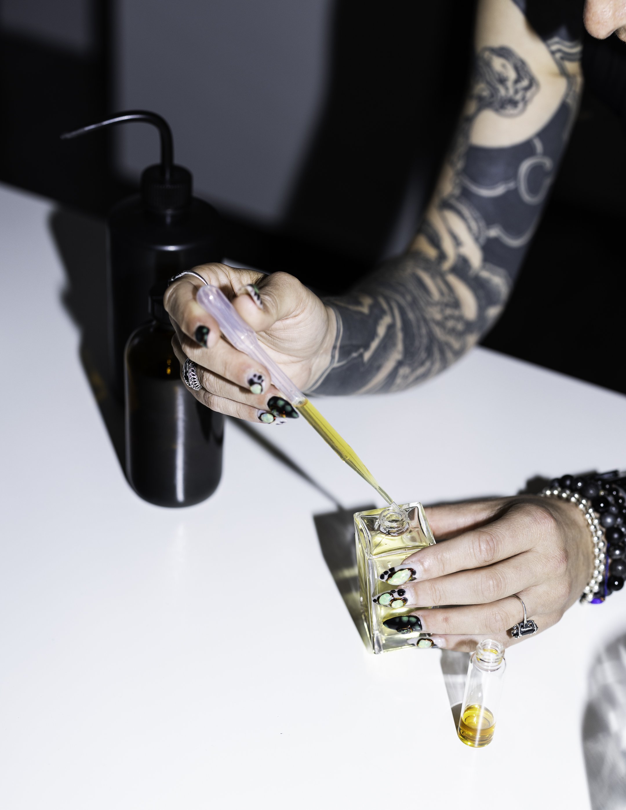 Perfumer, Tianna Blue, mixing a custom fragrance into a bottle in the Los Angeles perfume lab