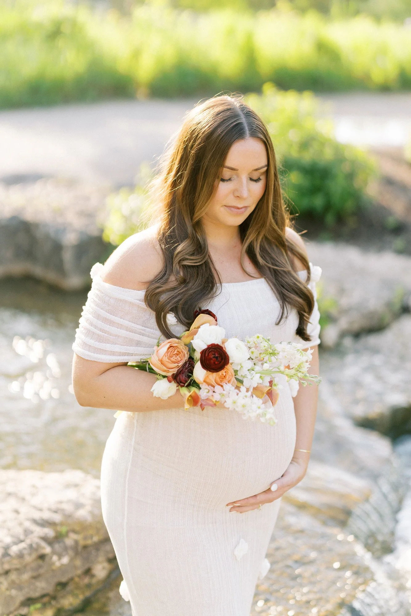 Outdoor maternity portrait of expectant mother holding flowers in St. Louis, Missouri by Tristan Singleton Photography