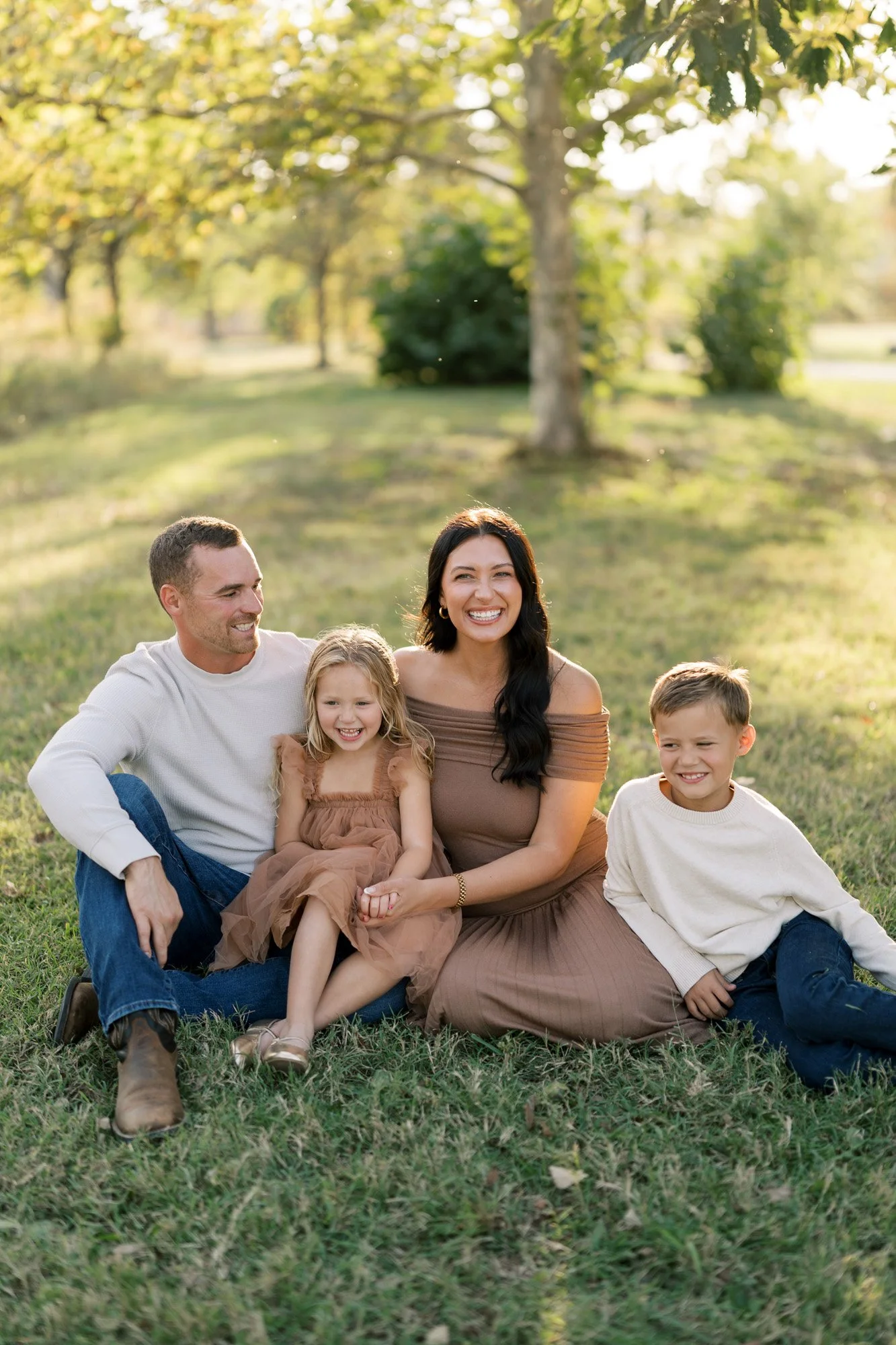 Family sitting on ground in Forest Park photo session
