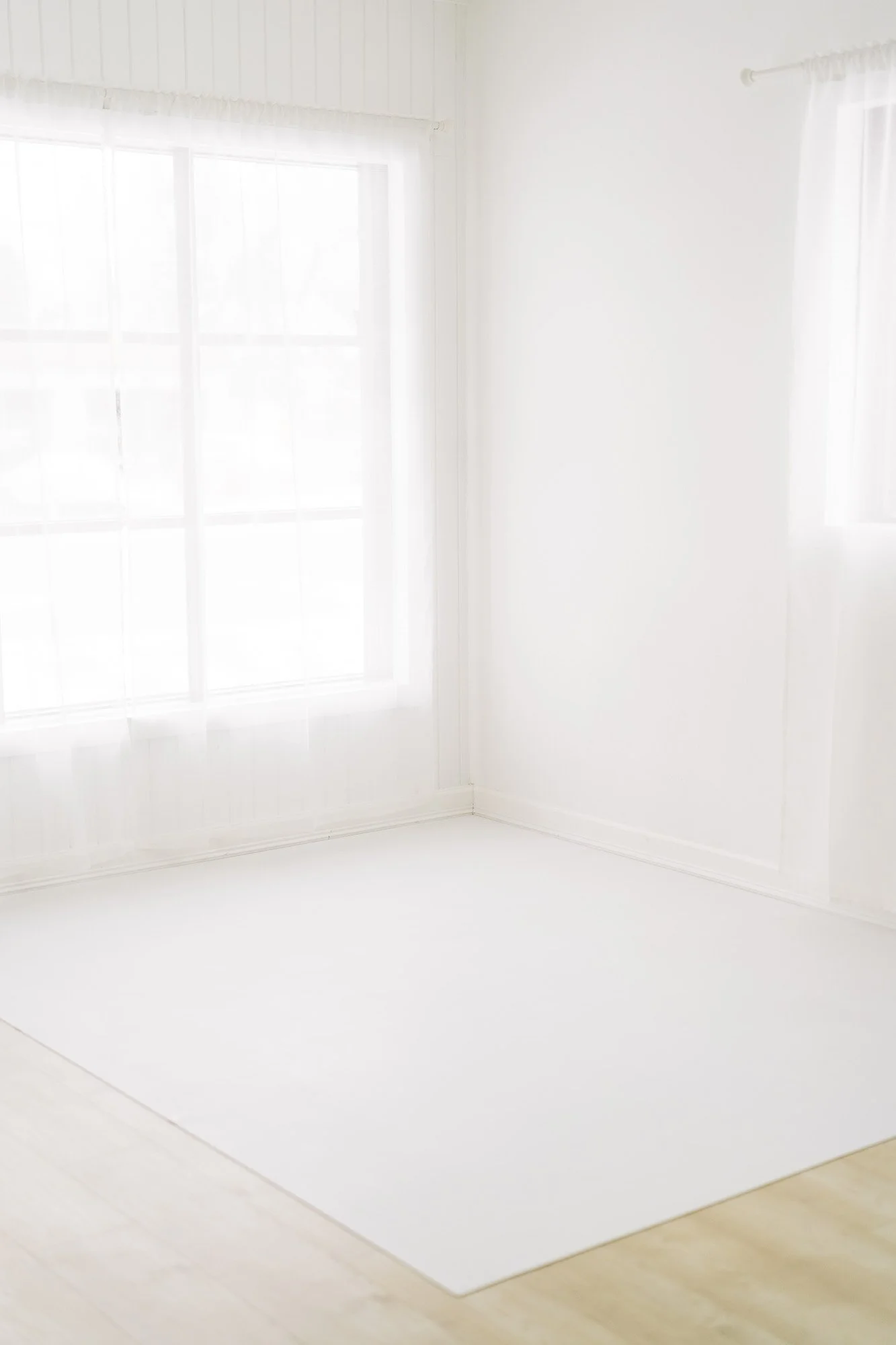 Singleton Studio corner windows and white floor mat natural light