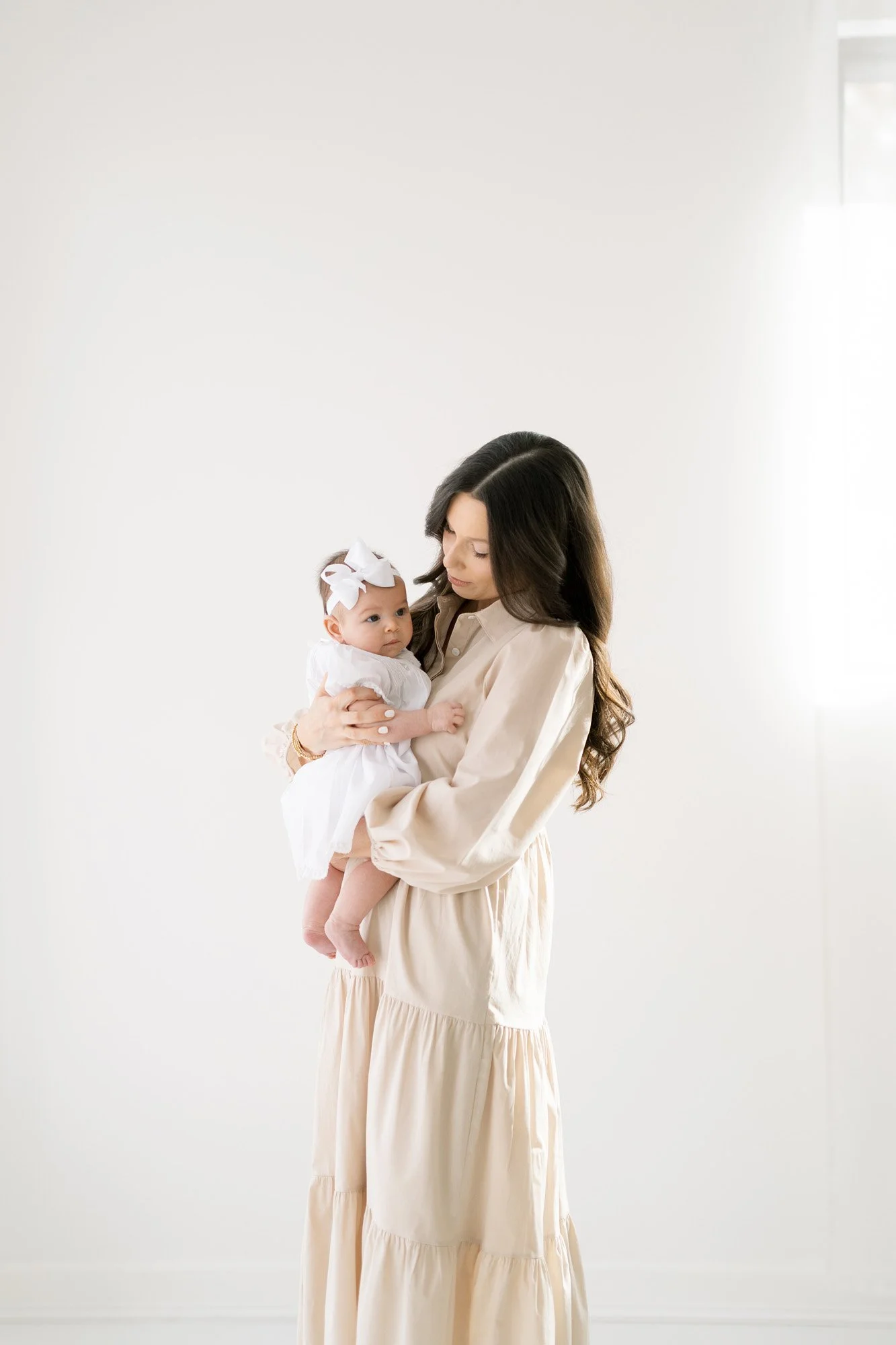 Mother holding baby in Kirkwood studio portrait session by Tristan Singleton Photography