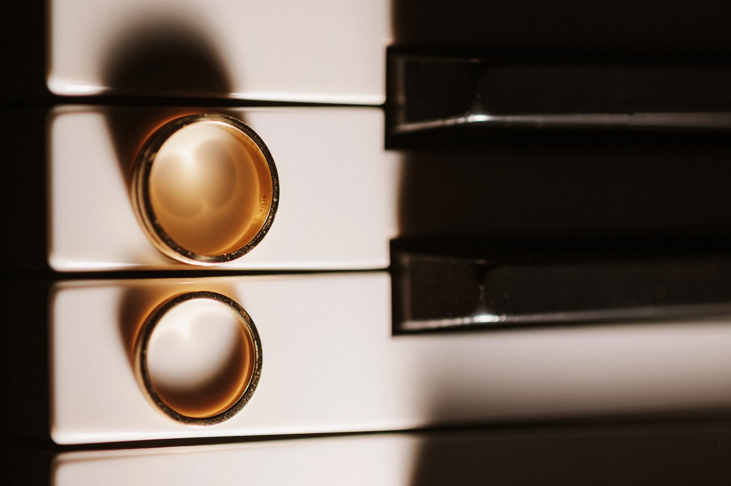 Close-up of two cream-colored oven knobs on a white oven, with black control panels visible on the right side.
