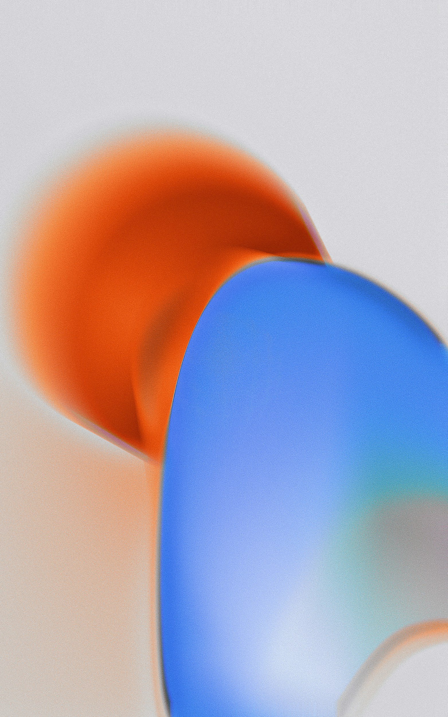 Abstract close-up of curved shapes in orange, blue, and light gray colors.