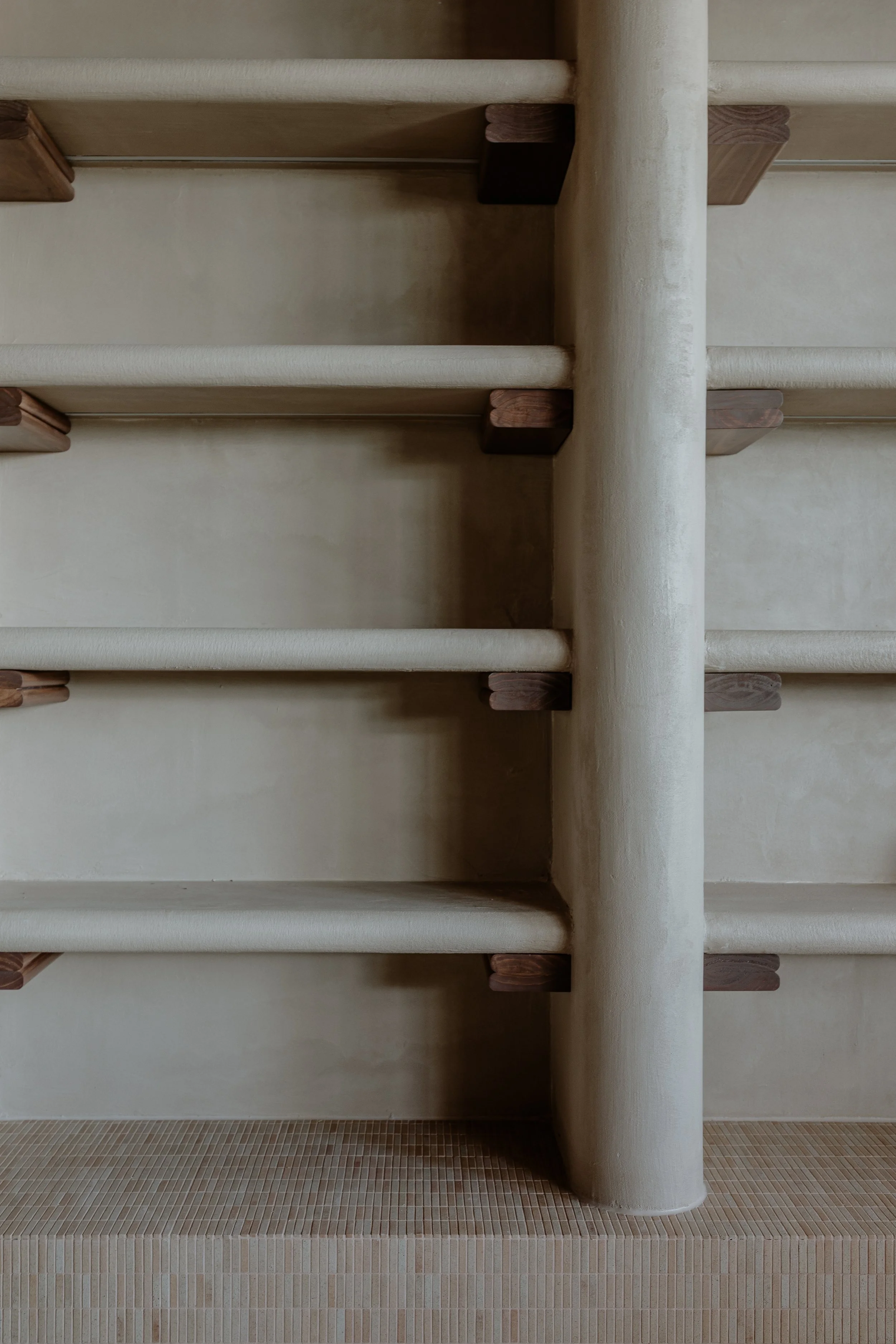 Close-up of a wine shelving for a Italian restaurant, with custom timber supports and rounded columns