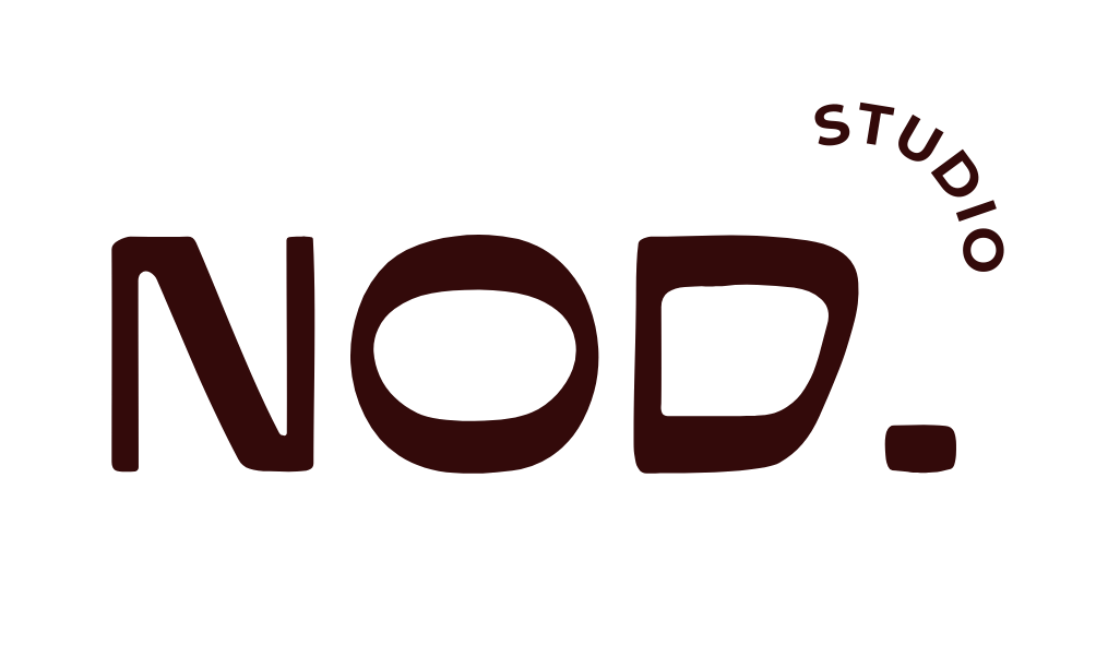 Logo with the text 'NOD. STUDIOS' in dark red, with 'NOD.' in large letters and 'STUDIOS' curved above it.