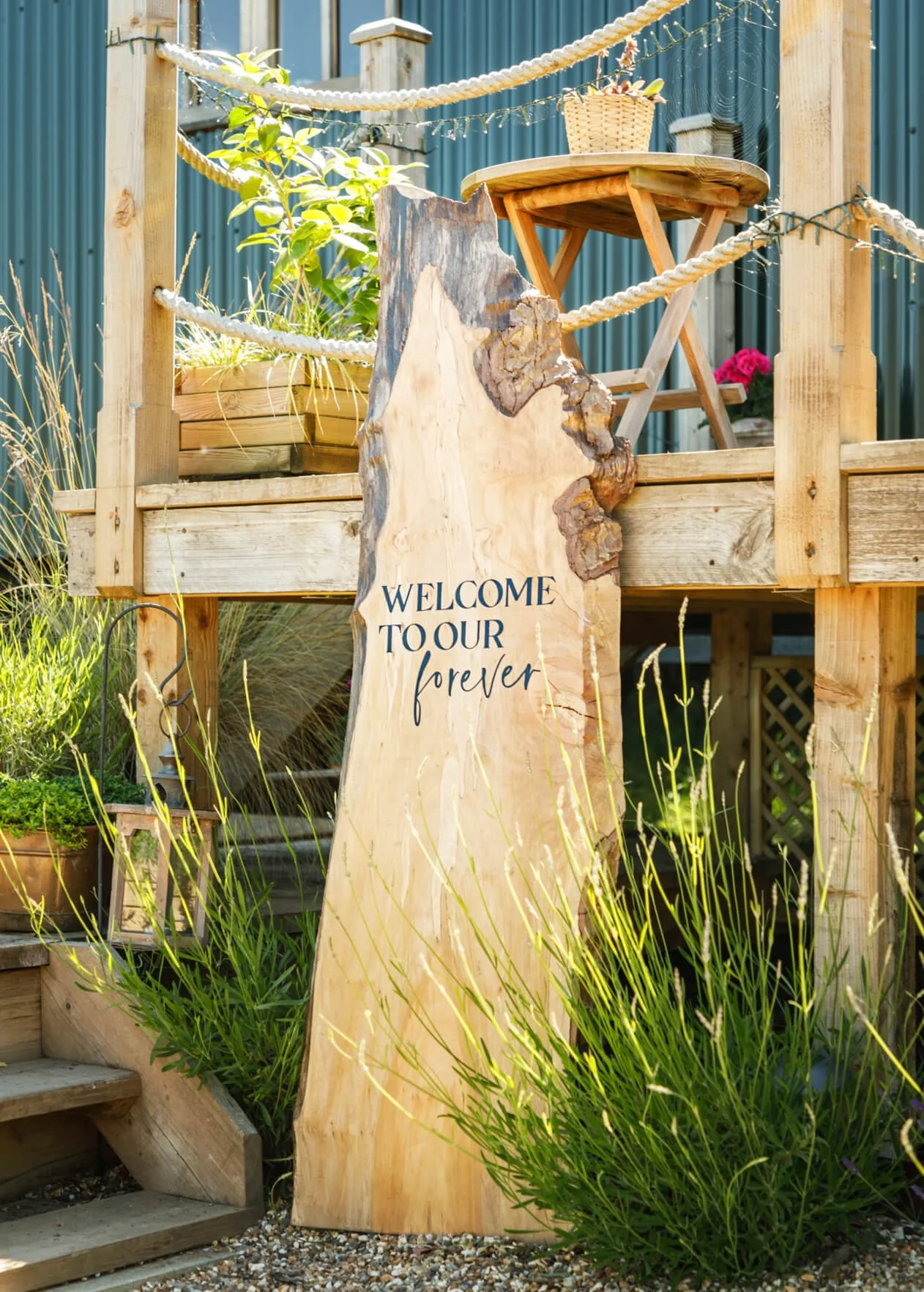 Freestanding wedding signage installation combining guest information, photographs and custom design elements for a personalised celebration.
