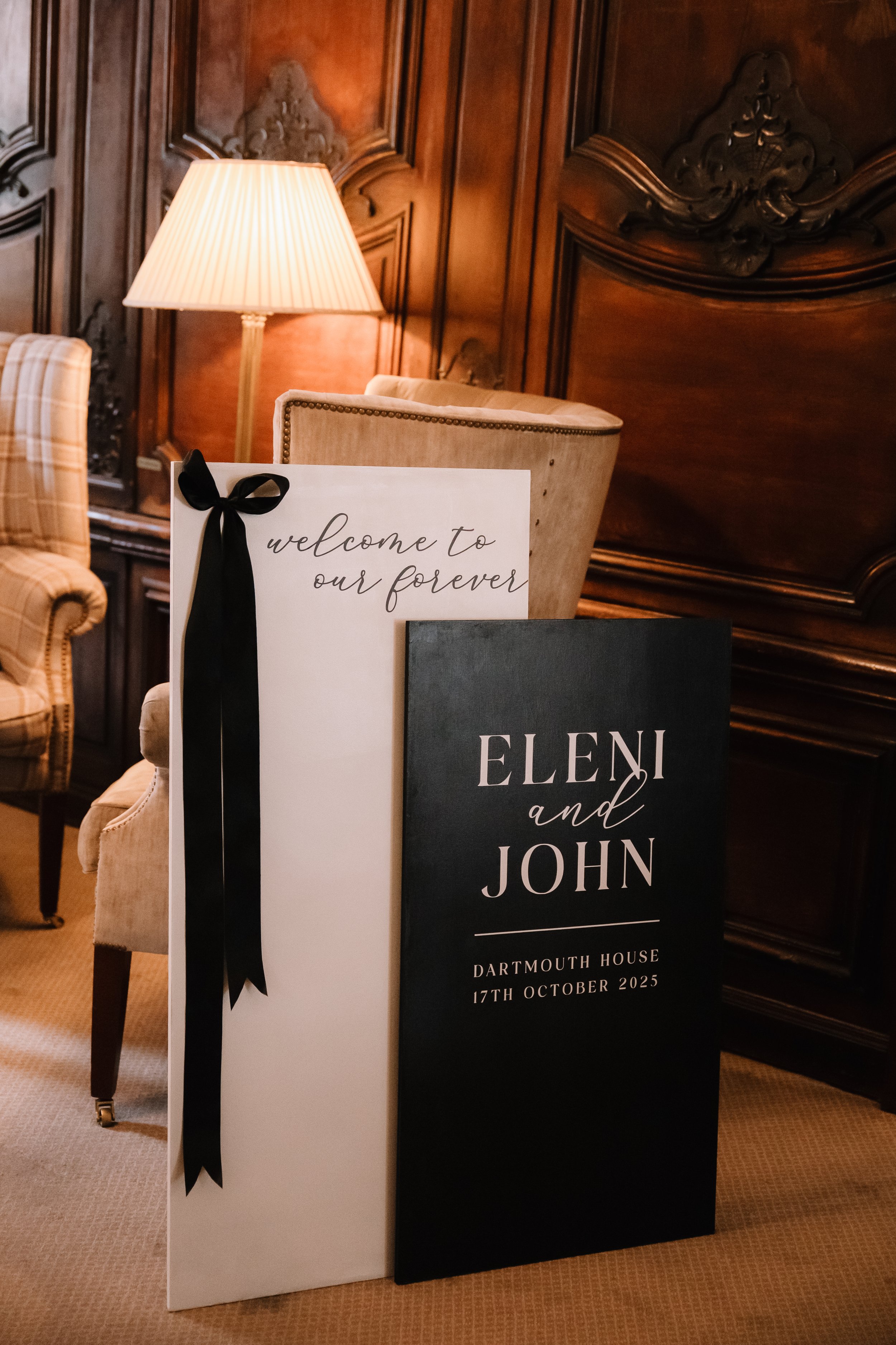 Luxury wedding welcome sign styled with black ribbon detailing, designed to greet guests and complement the wedding aesthetic.