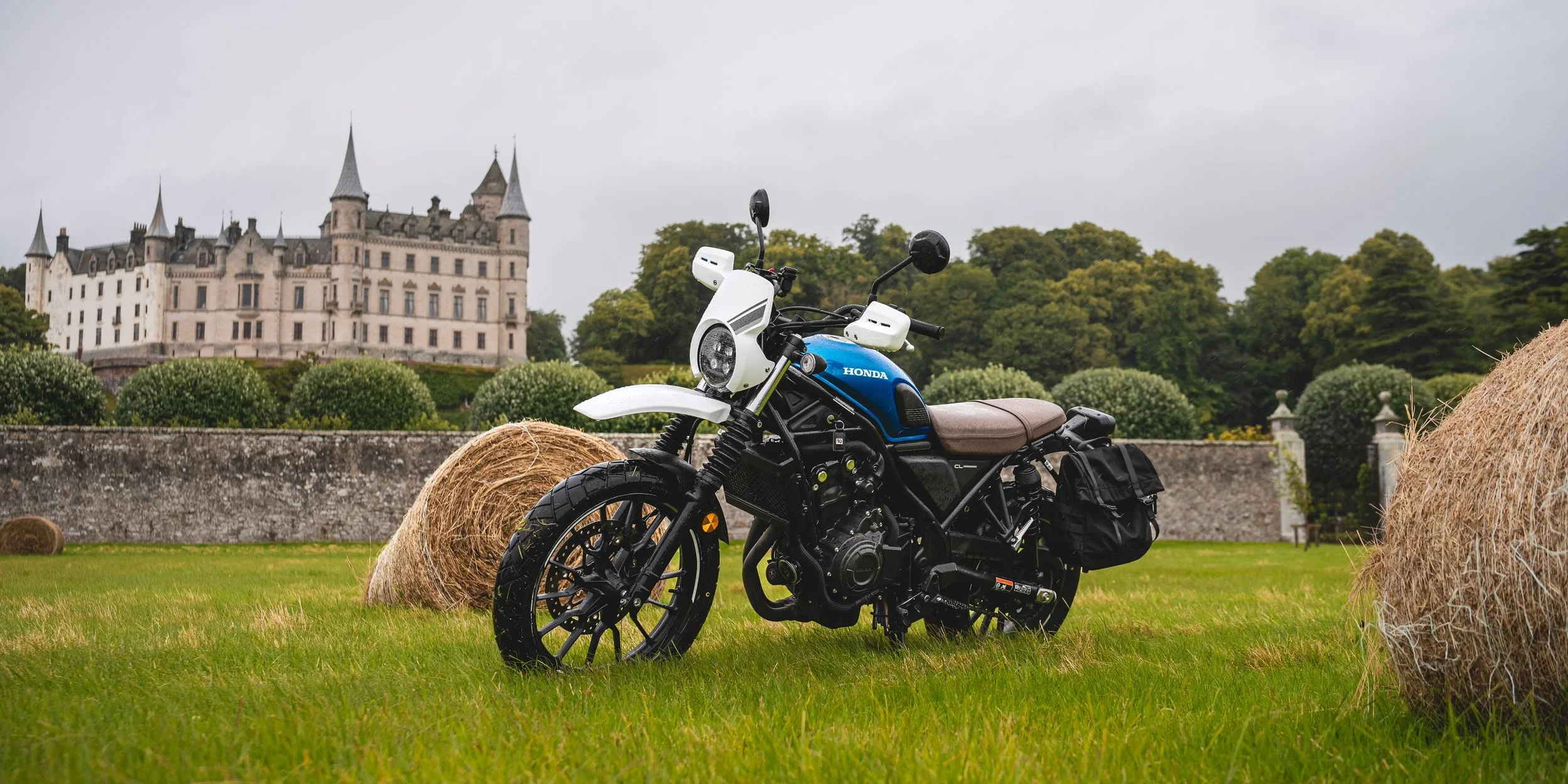 Motorcycle, Honda CL500 blue in frond of castle