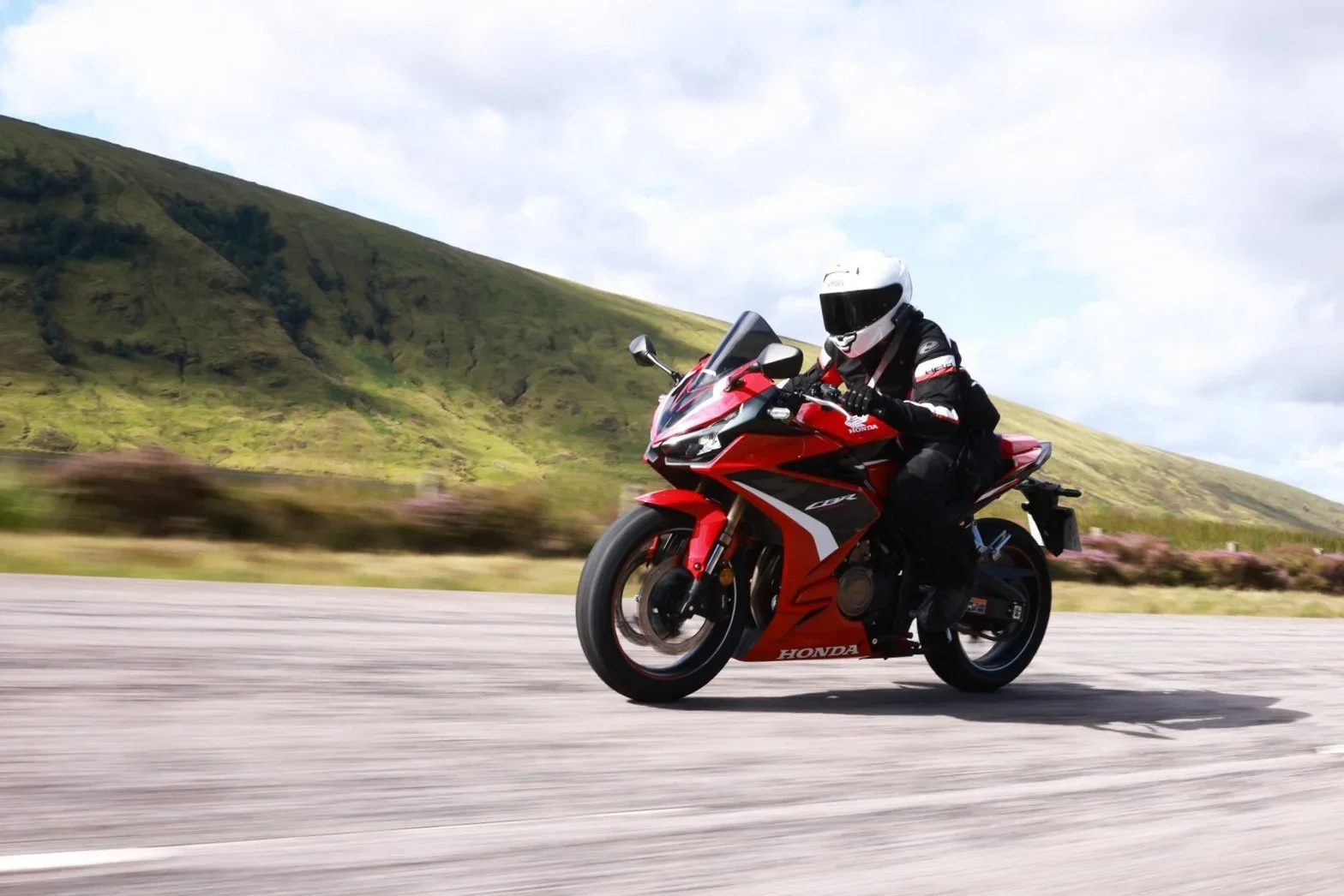 Girl racing on CBR500R in nature