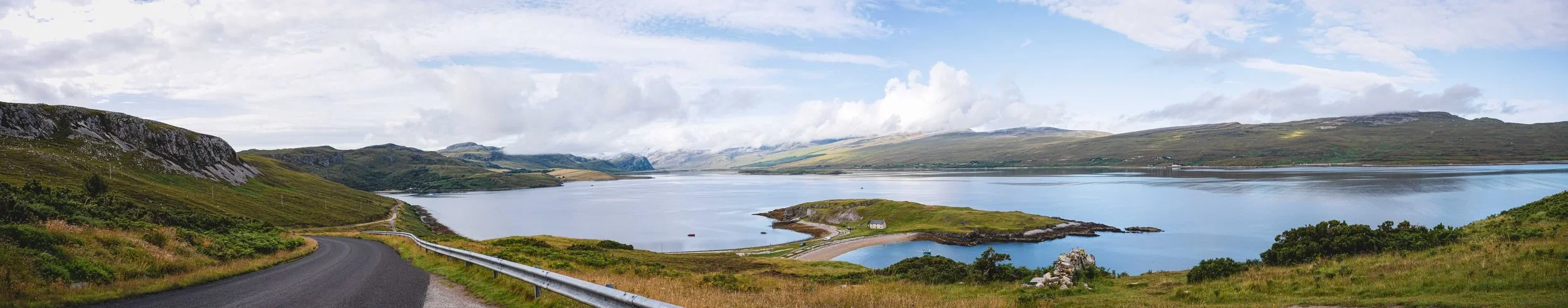 Scottish landscape panorama, lake with road and island