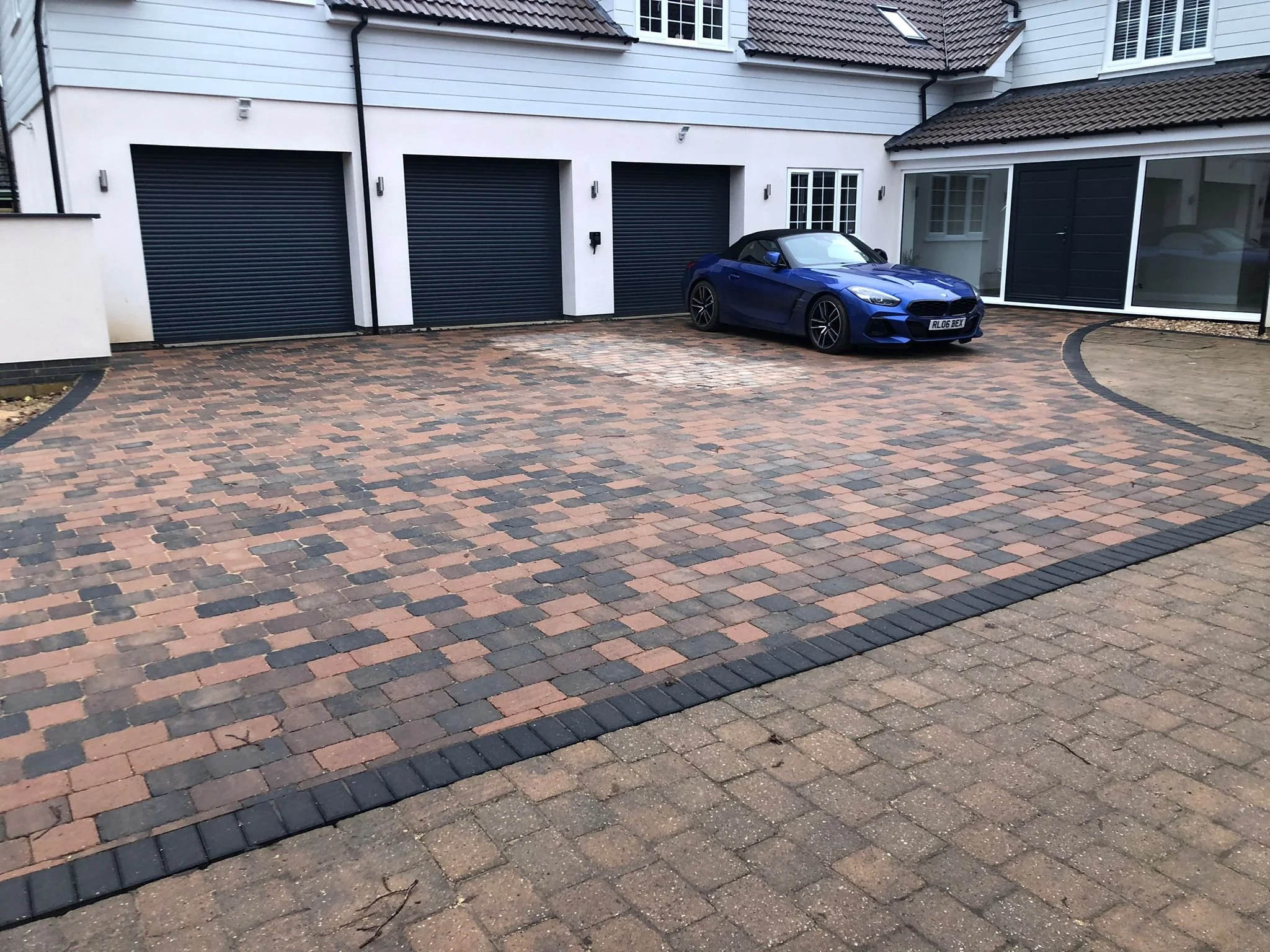 Driveway with interlocking brick pavers completed by local Grantham builder G East Builder.