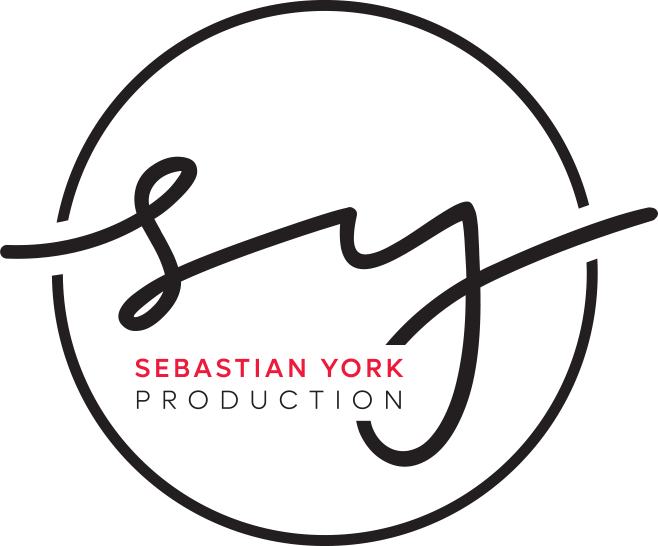 A circular logo with the stylized initials 'sy' in cursive black font. Inside the circle, the name 'SEBASTIAN YORK' in red, capitalized, and 'PRODUCTION' in gray, capitalized, are written in a clean font.