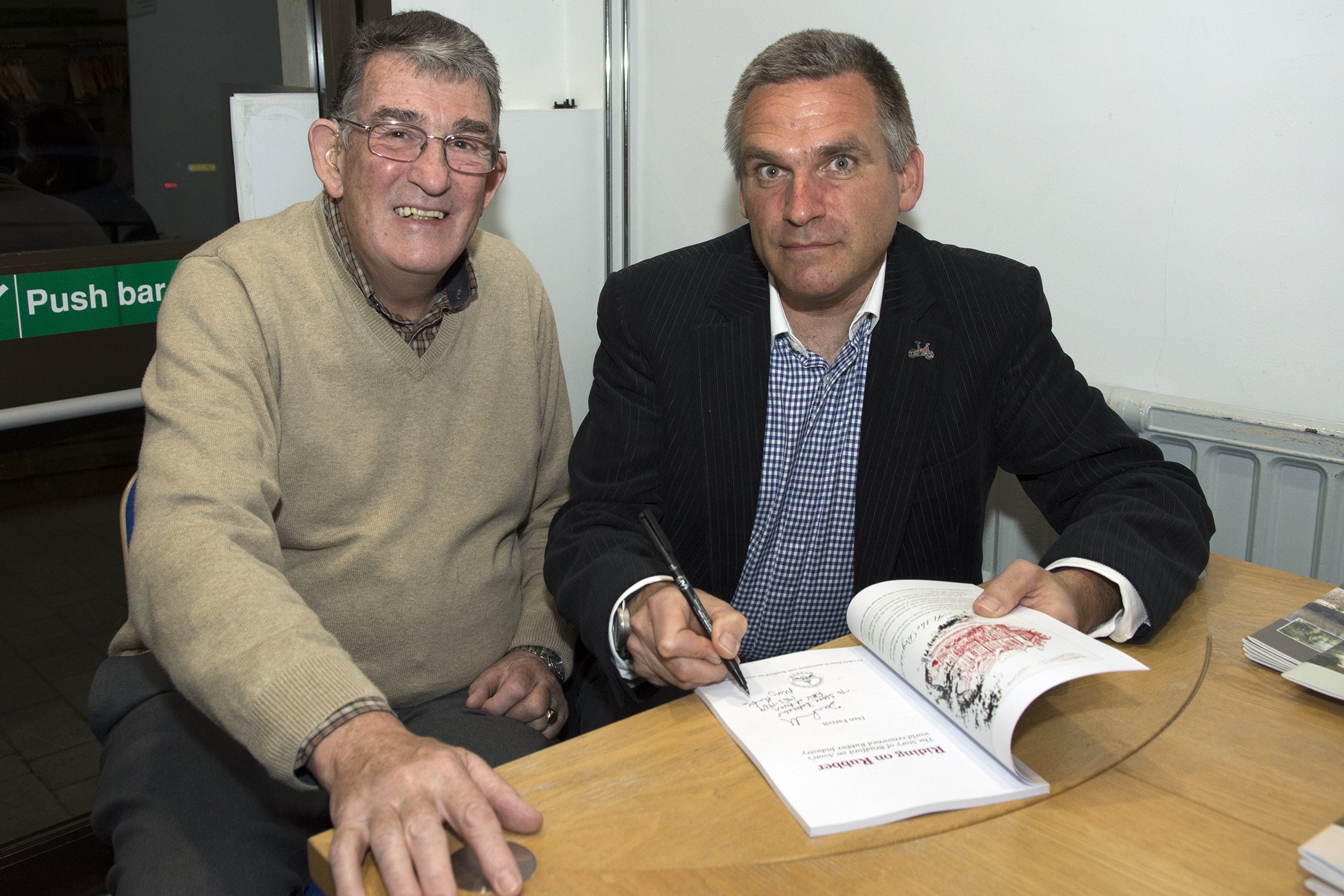 Dan Farrell signing his book Riding on Rubber