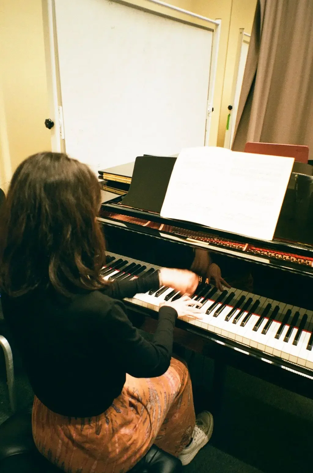 Antonia Clarke demonstrating technique on a grand piano