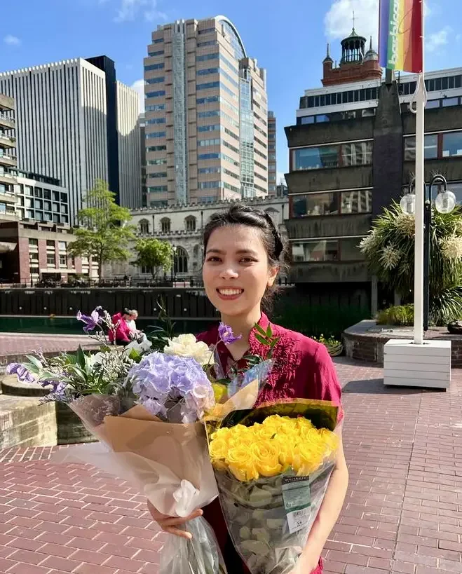Antonia Clarke holding flowers after a piano performance